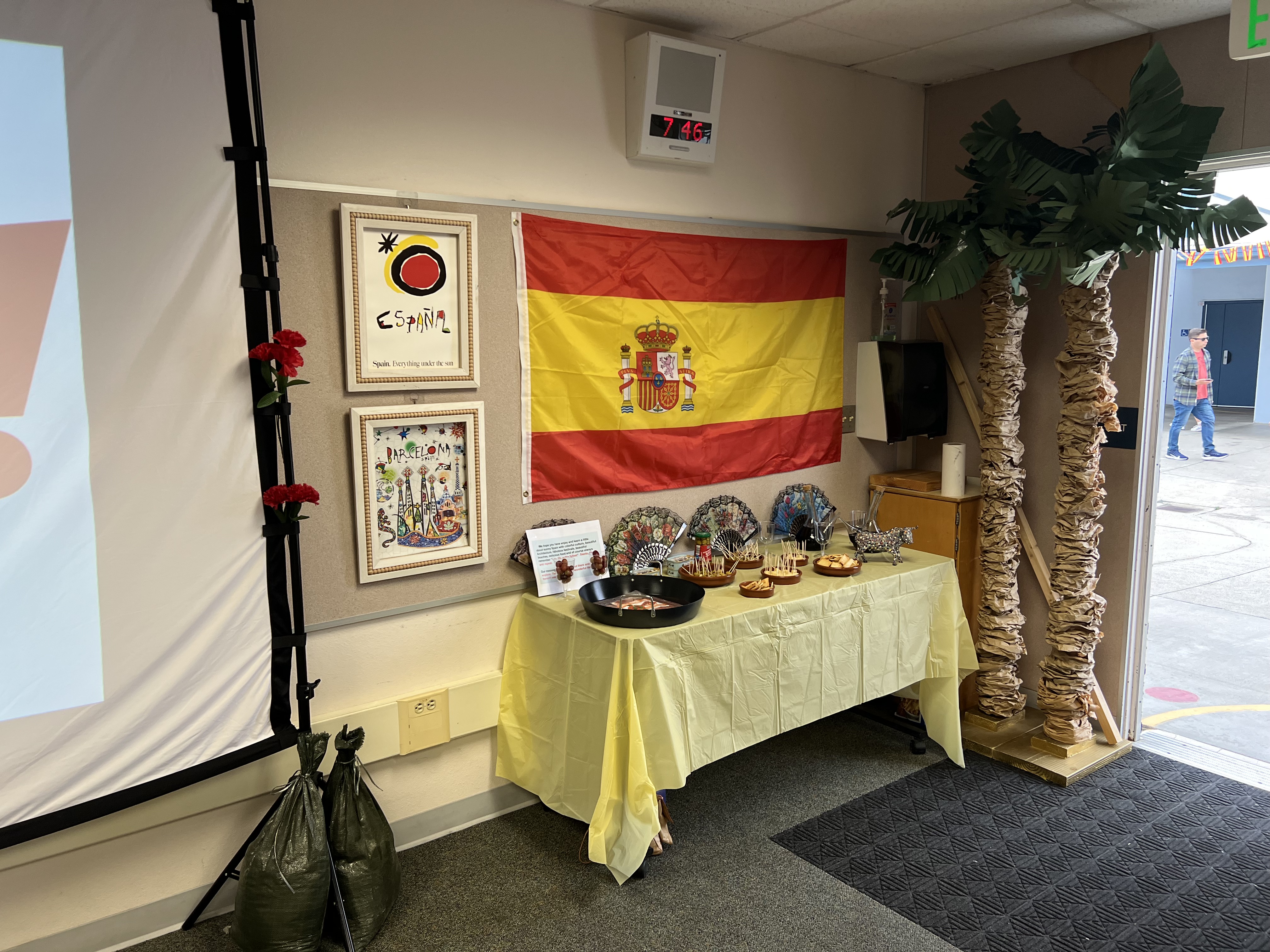 Img: flag, desk, table, person, plant, handbag, painting, shoe, monitor, plate