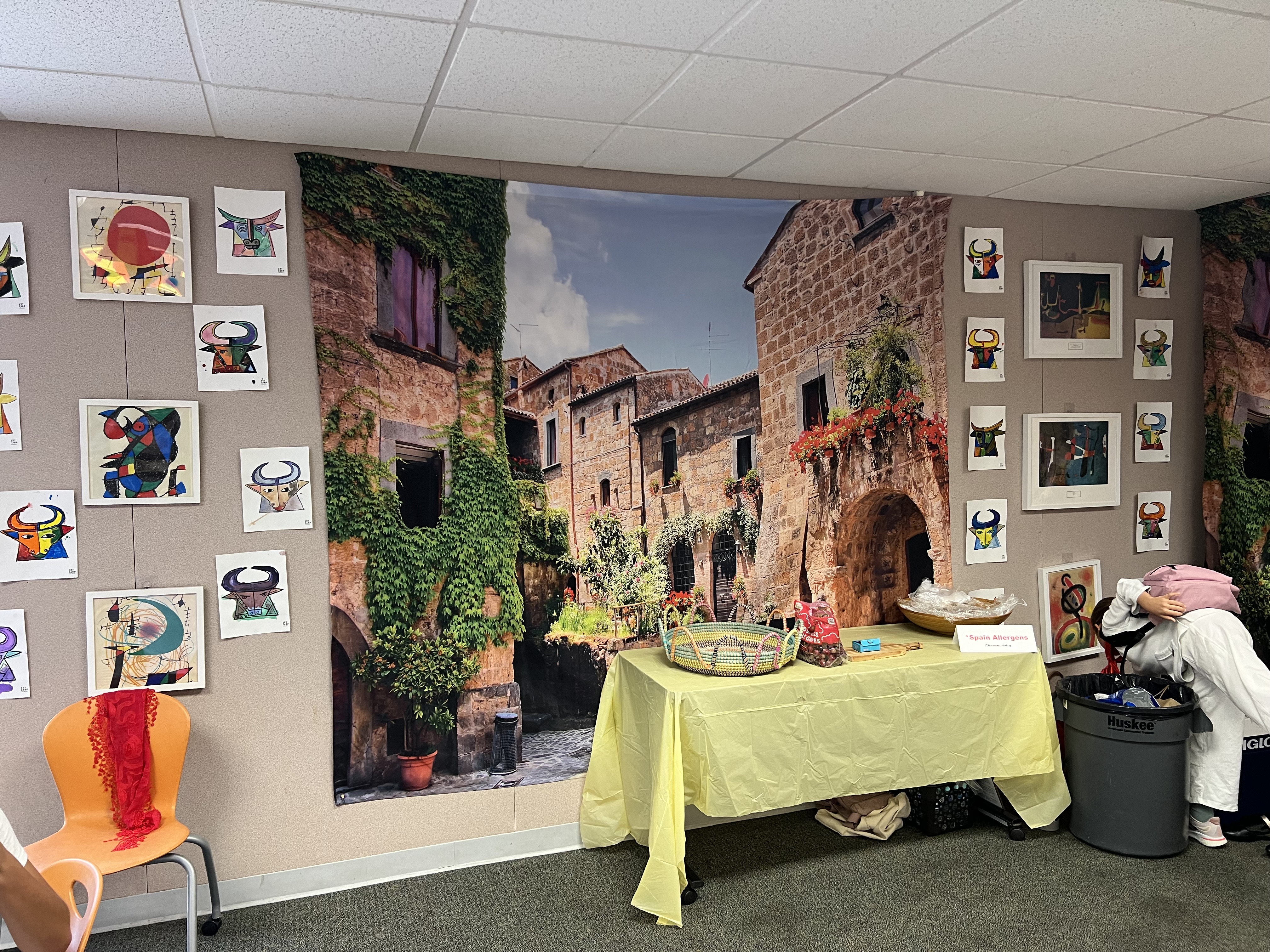 Img: potted plant, table, desk, indoors, interior design, living room, painting, person, chair, handbag