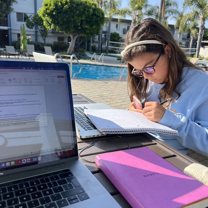 Img: computer, electronics, laptop, pc, person, glasses, table, pen, book, mobile phone