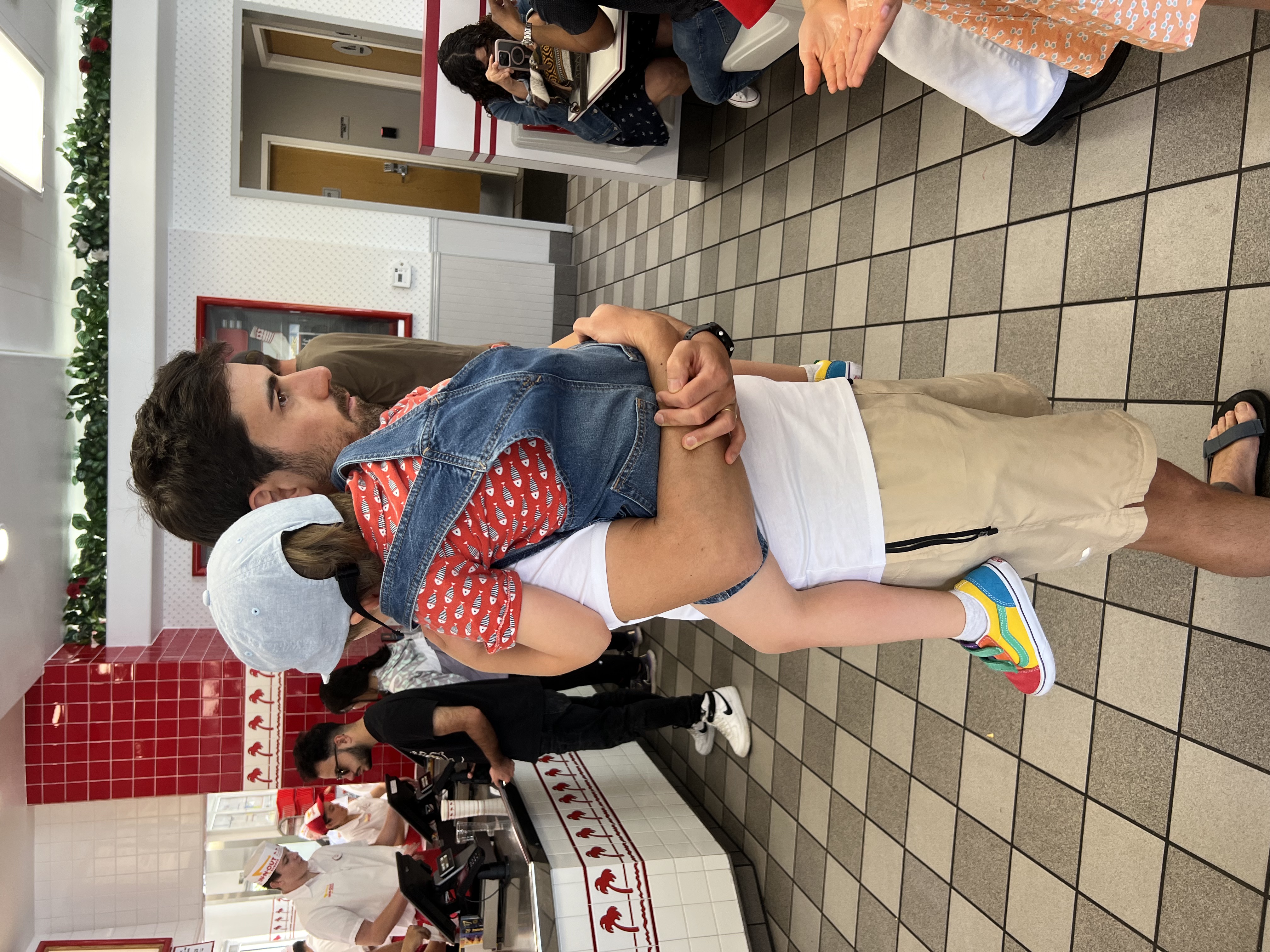 Img: shorts, shoe, hat, person, pants, wristwatch, adult, male, man, desk