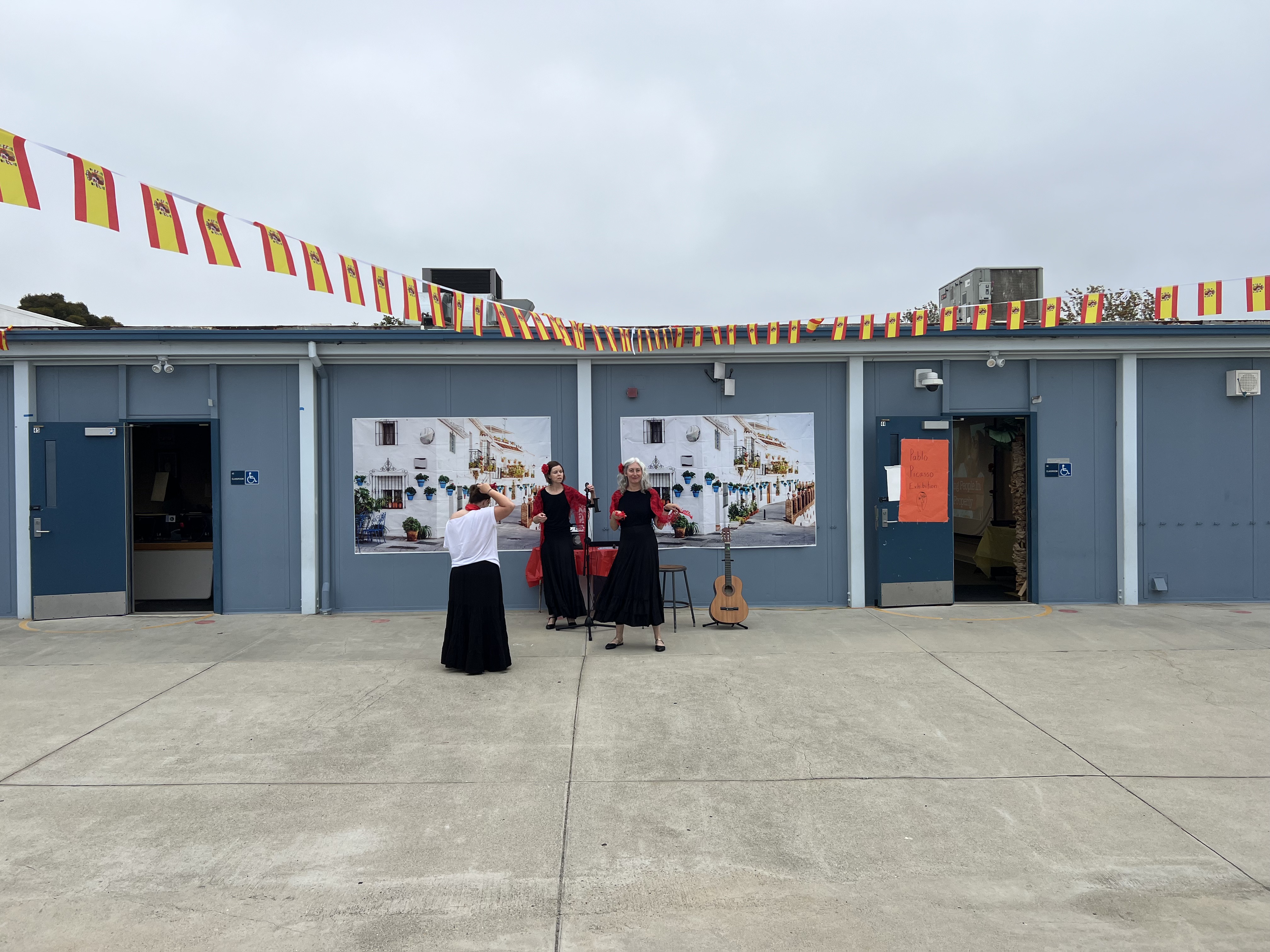 Img: floor, plant, flooring, person, guitar, musical instrument, handbag, dress, lamp, shoe