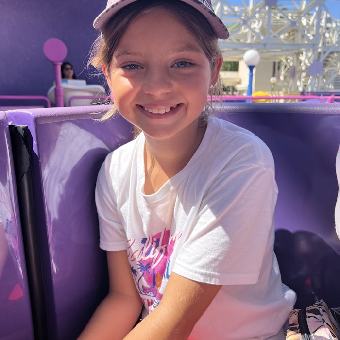 Img: face, head, person, smile, t-shirt, portrait, hat, baseball cap, cap, purple