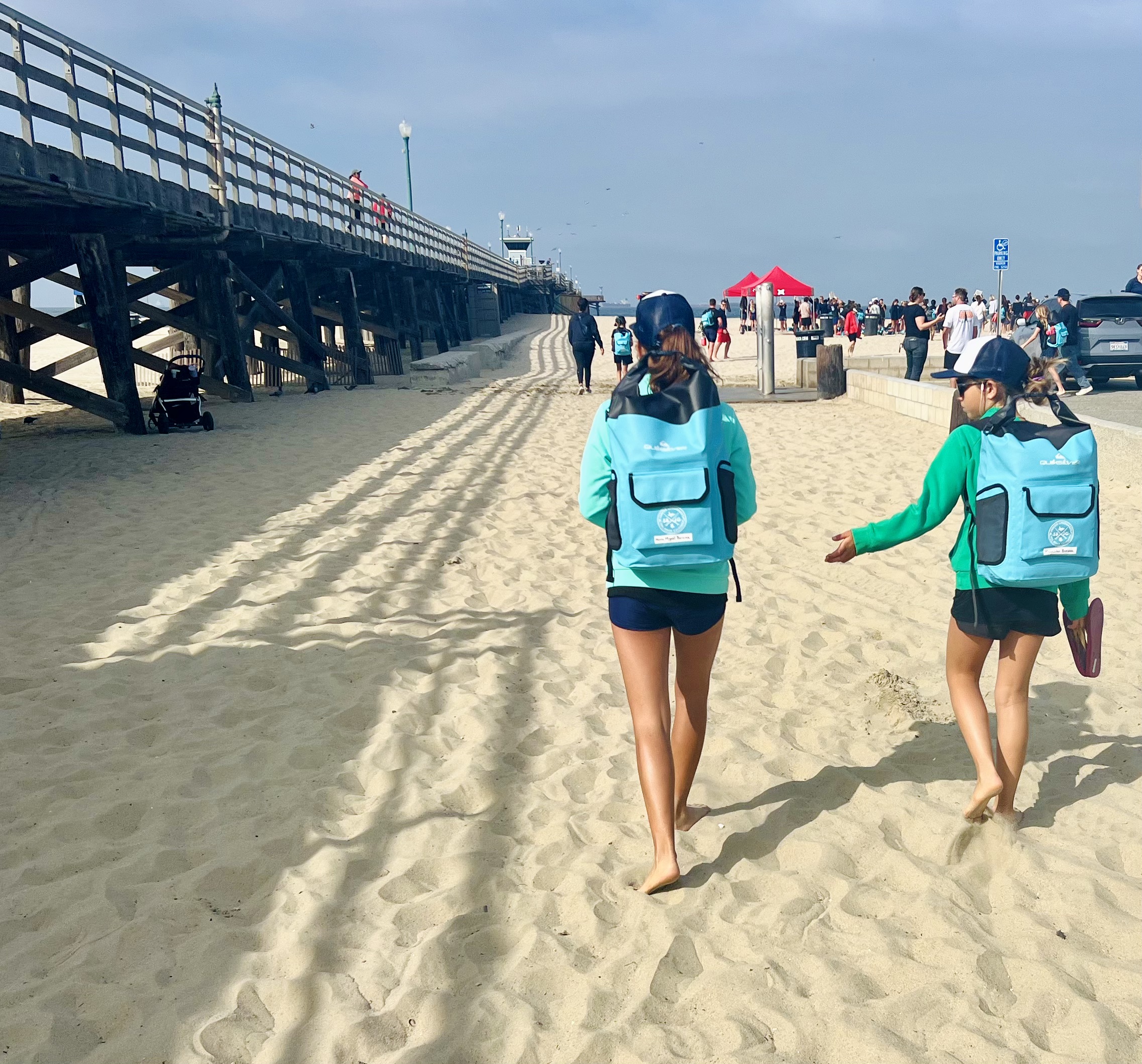 Img: water, waterfront, pier, person, shoe, hat, shorts, vacation, glasses, car