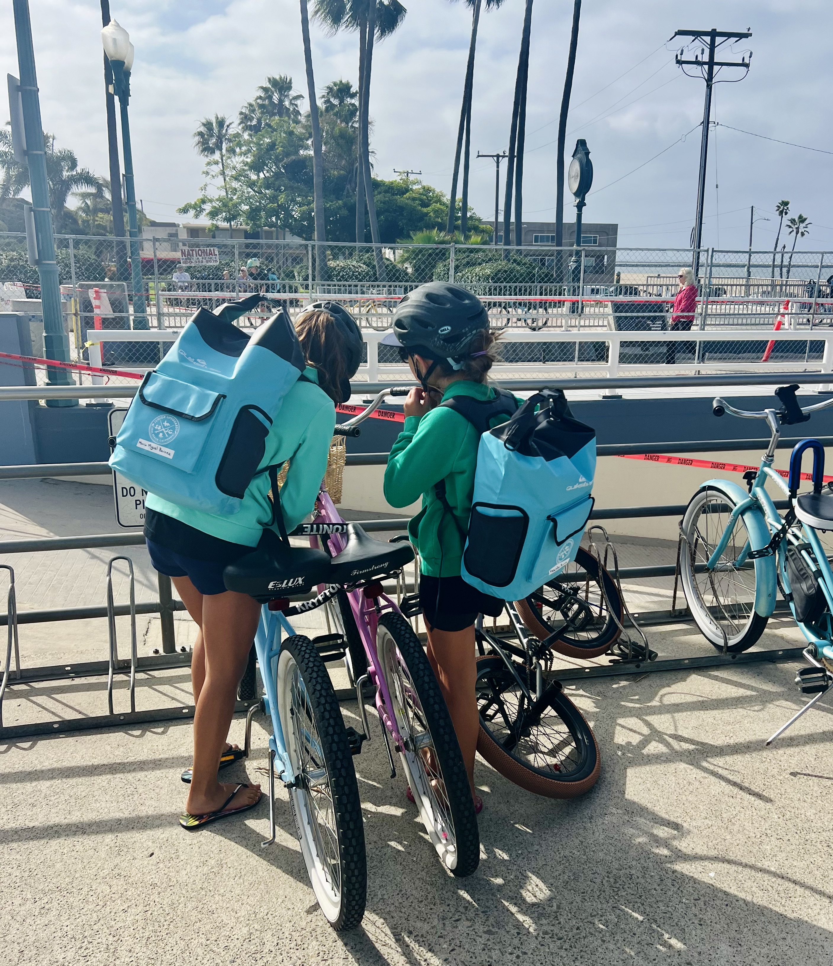 Img: helmet, backpack, bag, clothing, footwear, shoe, person, bicycle, vehicle, handbag