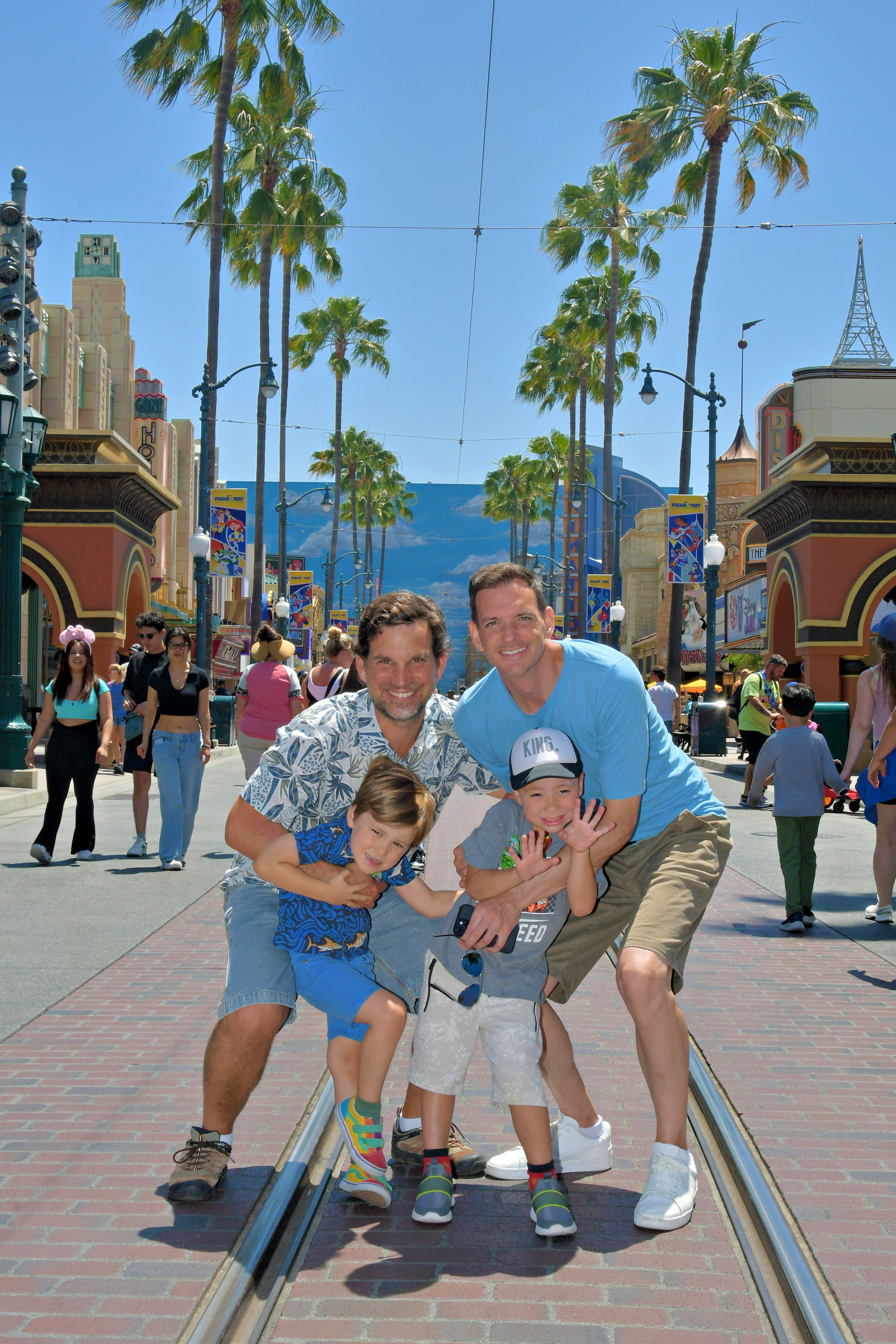 Img: shorts, path, shoe, sidewalk, tree, hat, walkway, adult, man, person