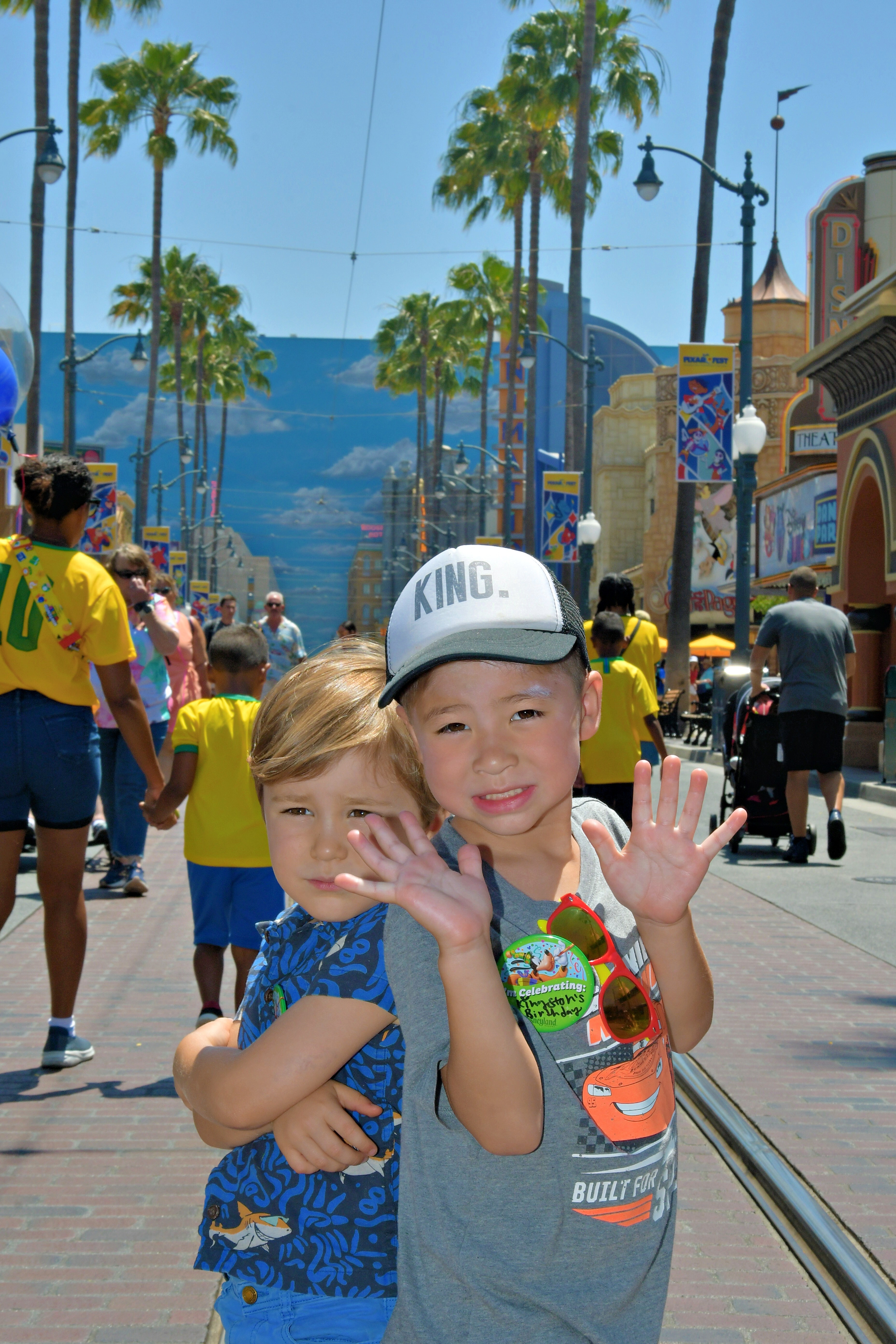 Img: path, sidewalk, baseball cap, hat, shorts, finger, person, summer, shoe, man