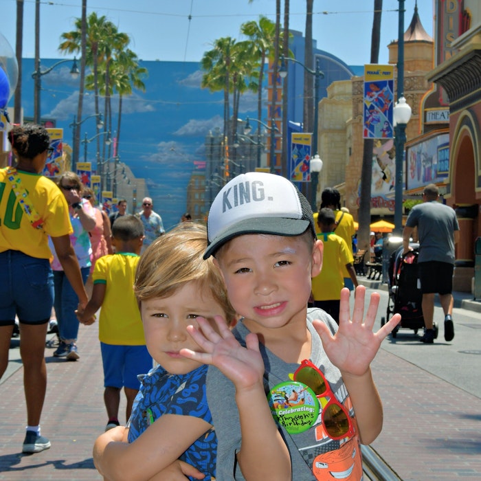 Img: path, sidewalk, baseball cap, hat, shorts, finger, person, summer, shoe, man