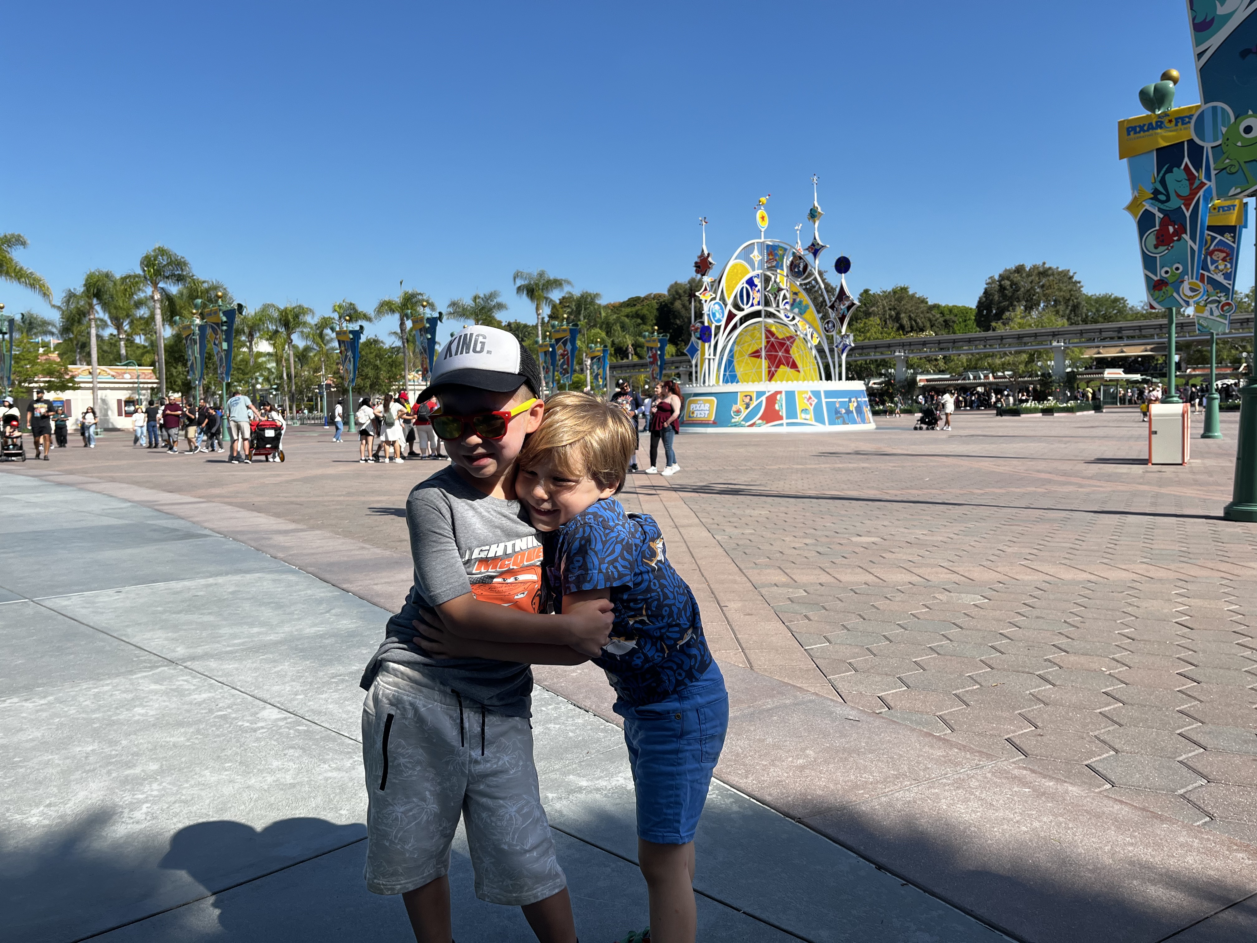 Img: pants, shorts, path, jeans, shoe, person, glasses, sidewalk, hat, walkway