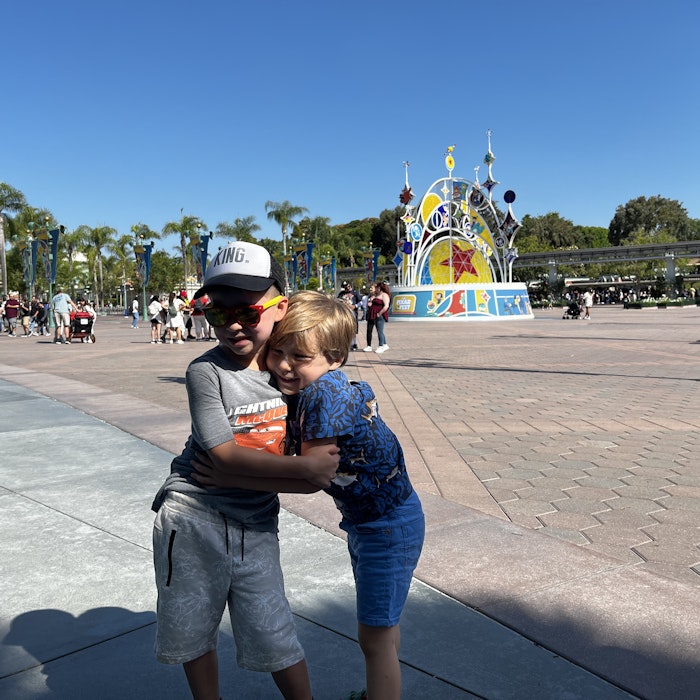 Img: pants, shorts, path, jeans, shoe, person, glasses, sidewalk, hat, walkway