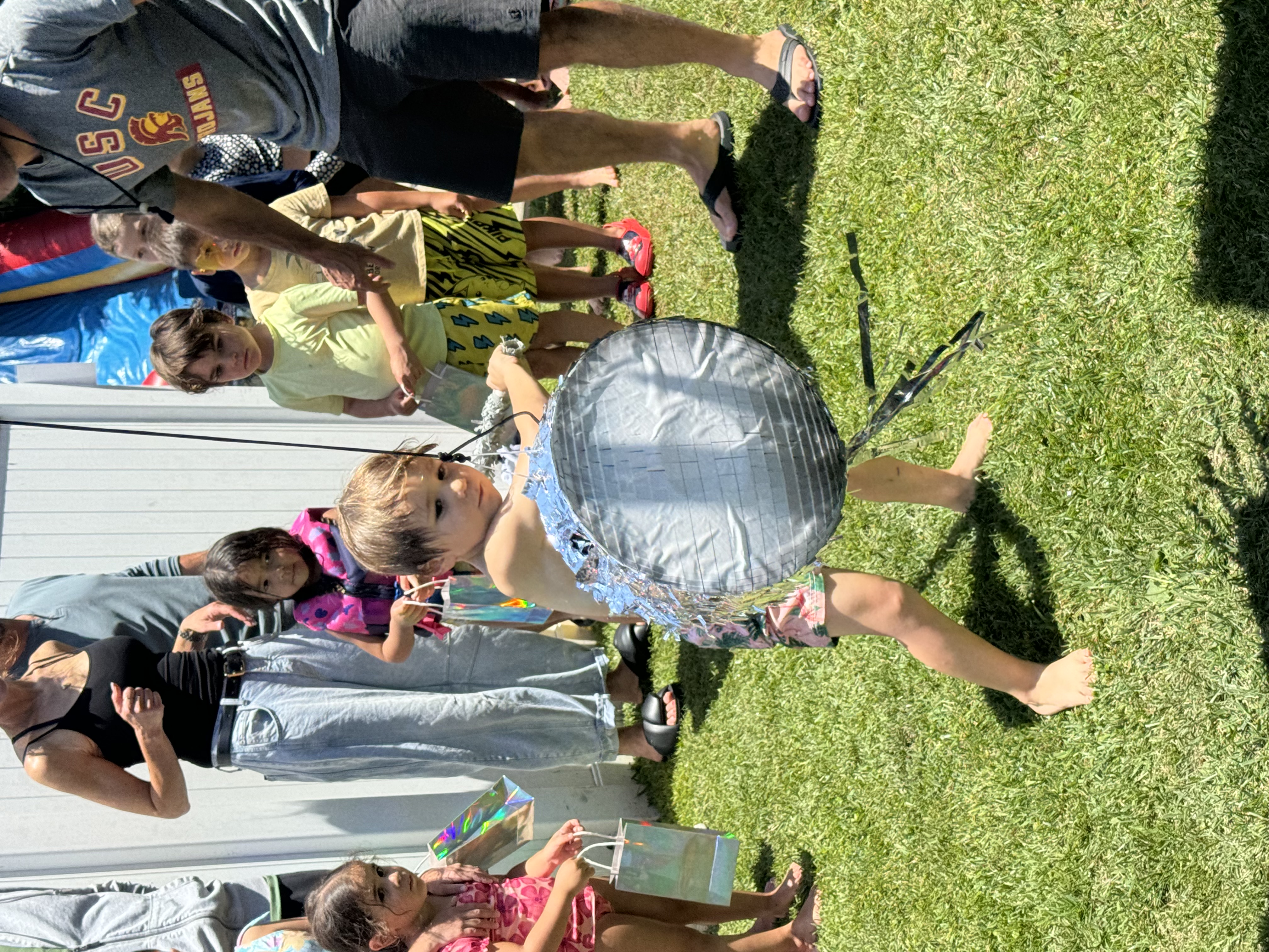 Img: grass, shorts, handbag, person, child, female, girl, adult, woman, shoe