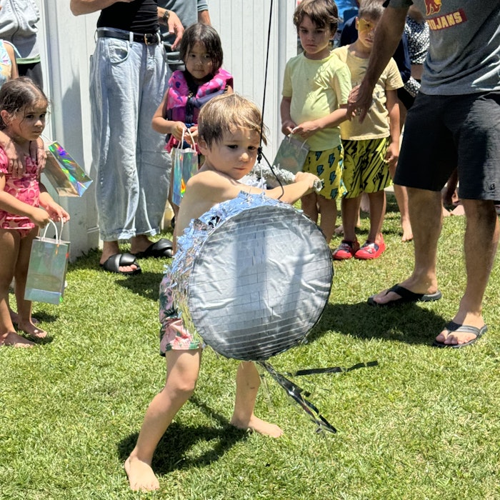 Img: grass, shorts, handbag, person, child, female, girl, adult, woman, shoe