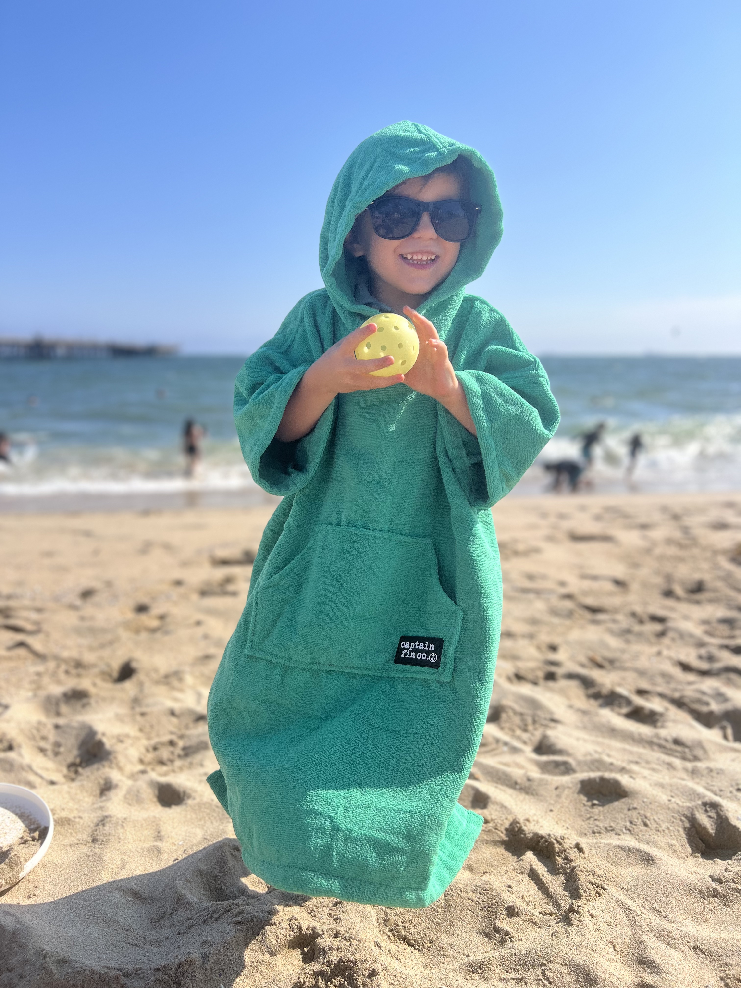 Img: clothing, coat, beachwear, photography, portrait, hoodie, beach, sea, hood, glasses