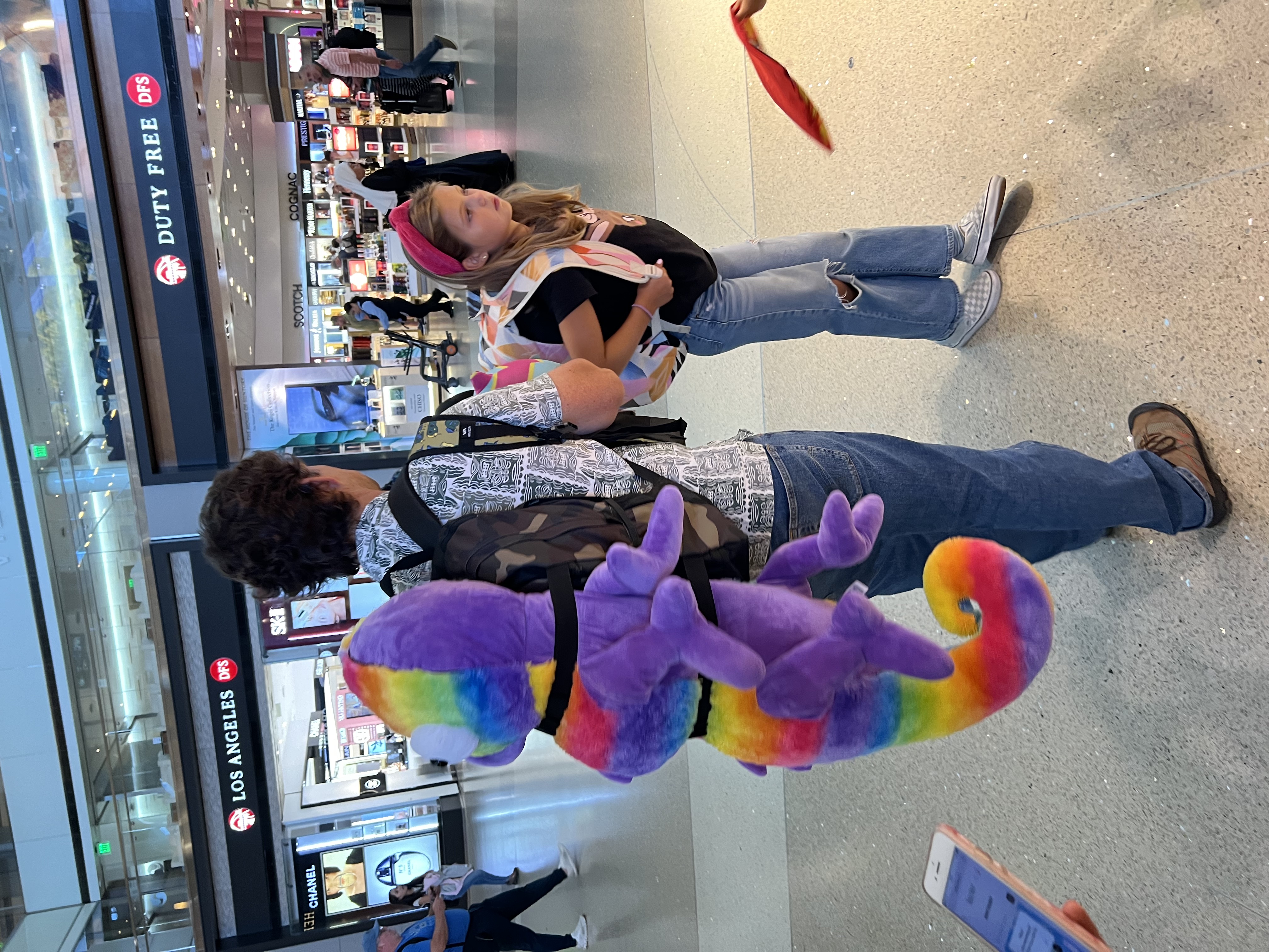 Img: pants, shoe, person, hat, urban, people, toy, mobile phone, terminal, costume