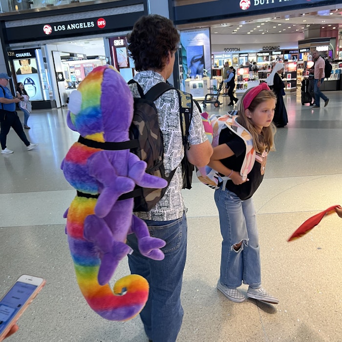 Img: pants, shoe, person, hat, urban, people, toy, mobile phone, terminal, costume