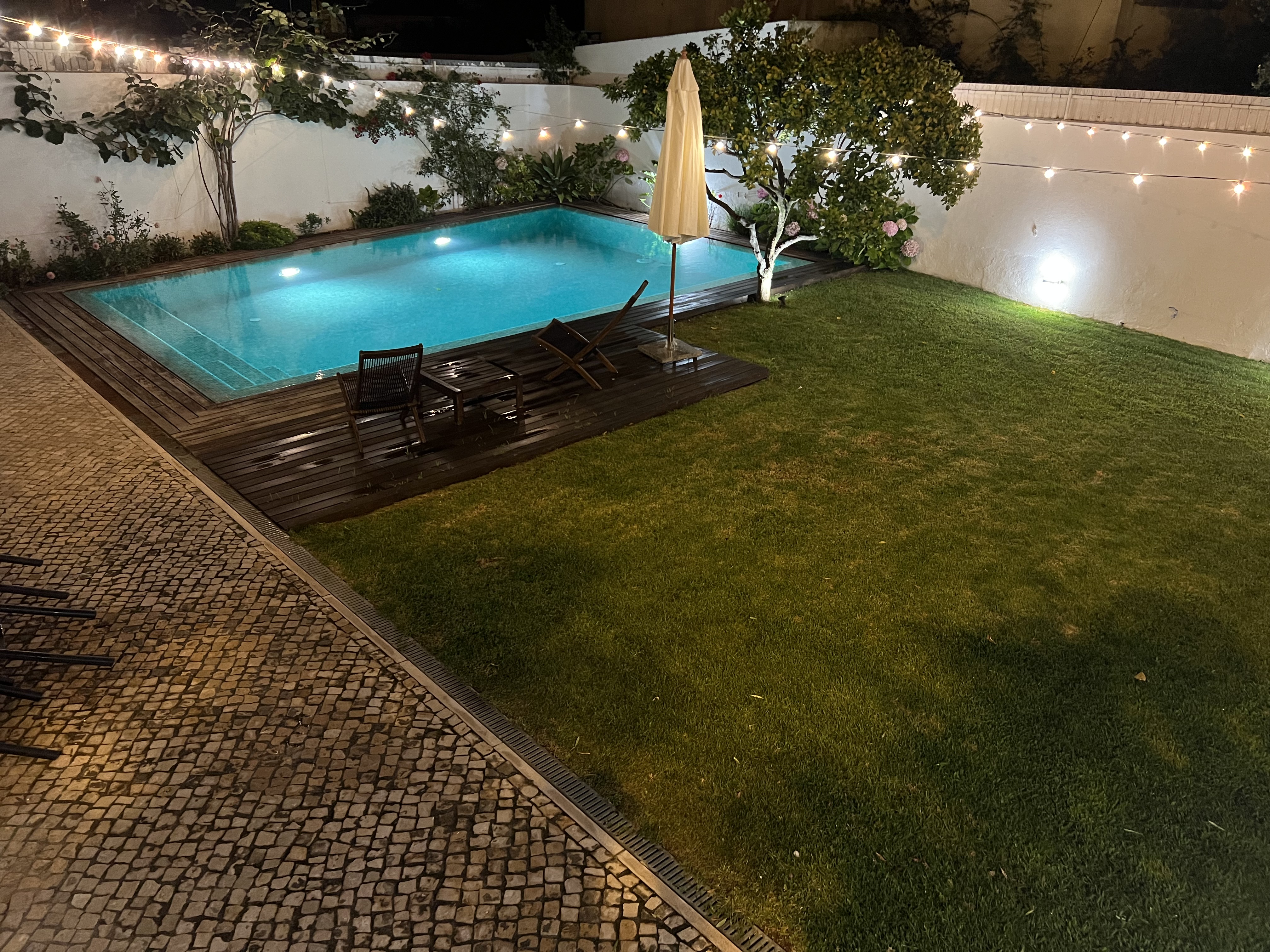 Img: pool, water, swimming pool, outdoors, backyard, chair, floor, grass, aerial view, candle