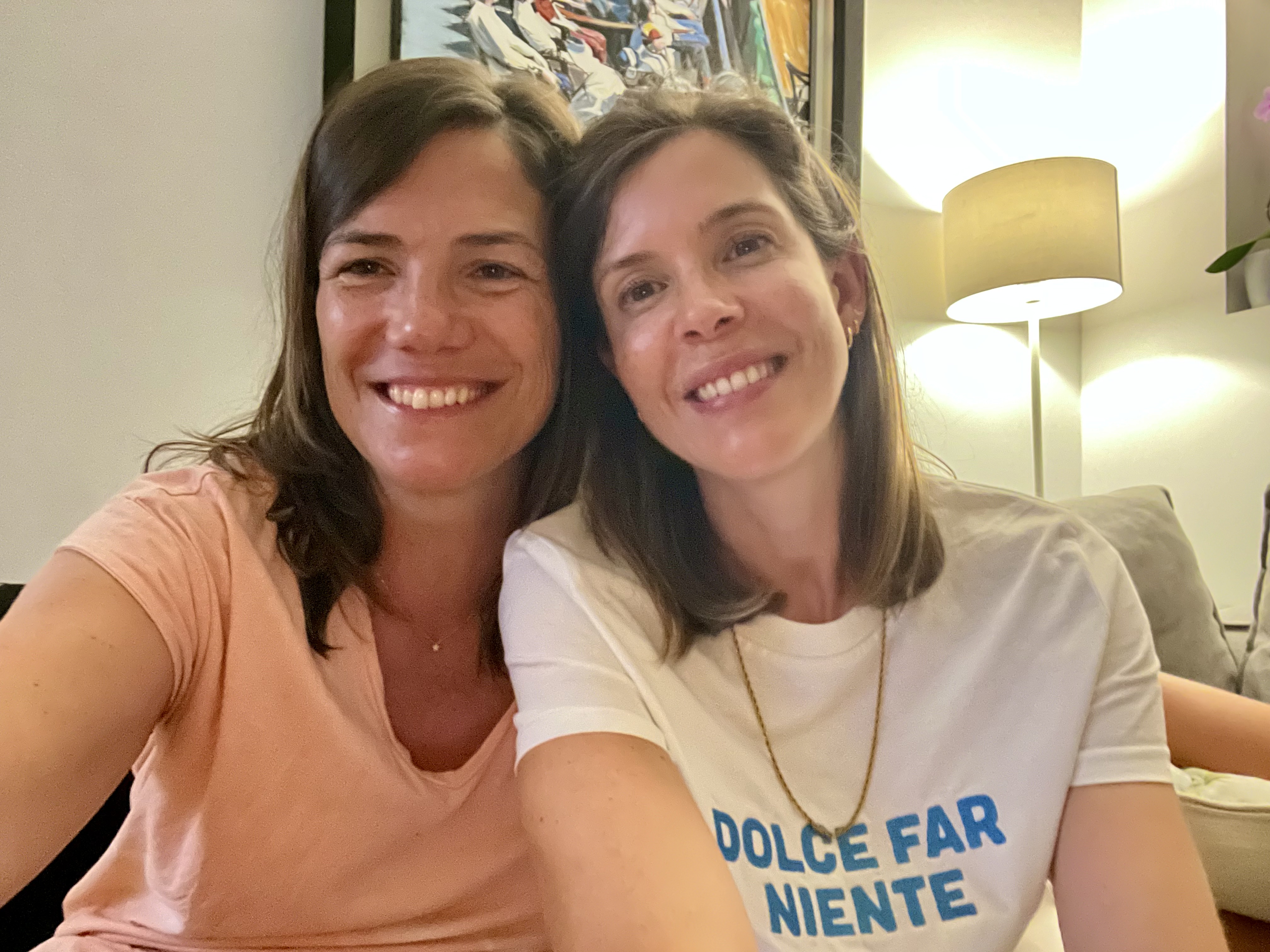 Img: lamp, necklace, t-shirt, face, head, person, smile, adult, female, woman