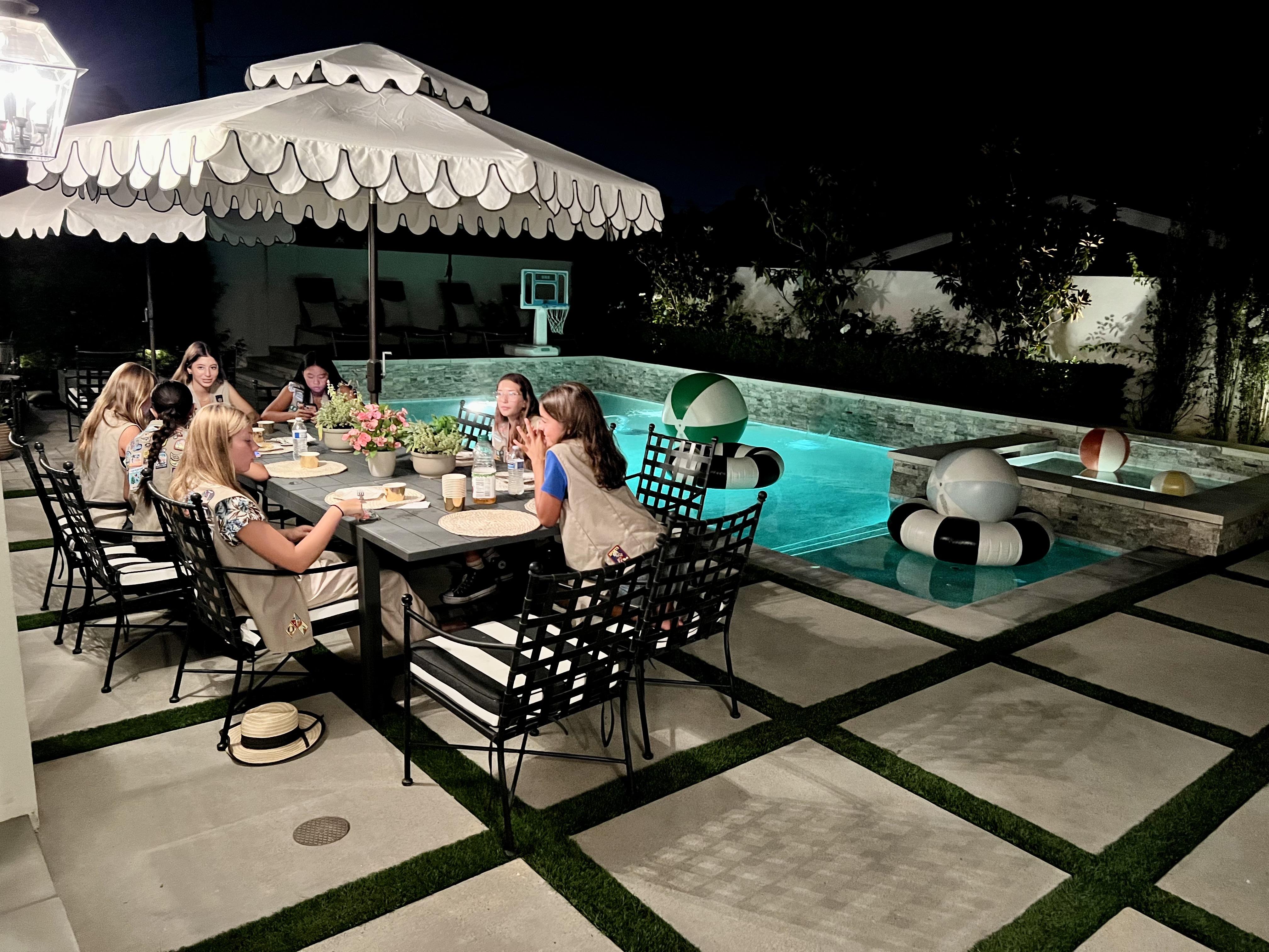 Img: dining table, furniture, table, dining room, restaurant, cup, hotel, patio, pool, person