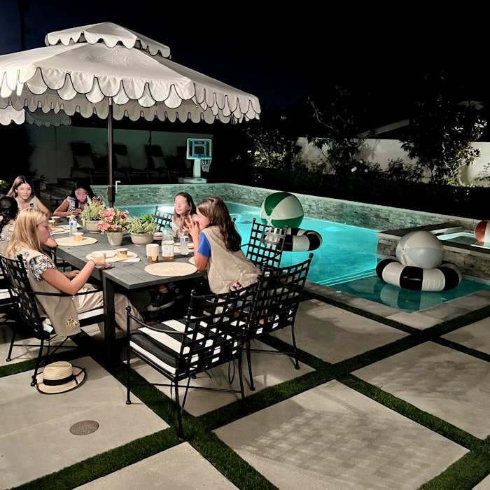 Img: dining table, furniture, table, dining room, restaurant, cup, hotel, patio, pool, person