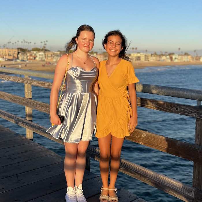 Img: waterfront, dress, evening dress, formal wear, boardwalk, pier, person, handrail, sandal, wood