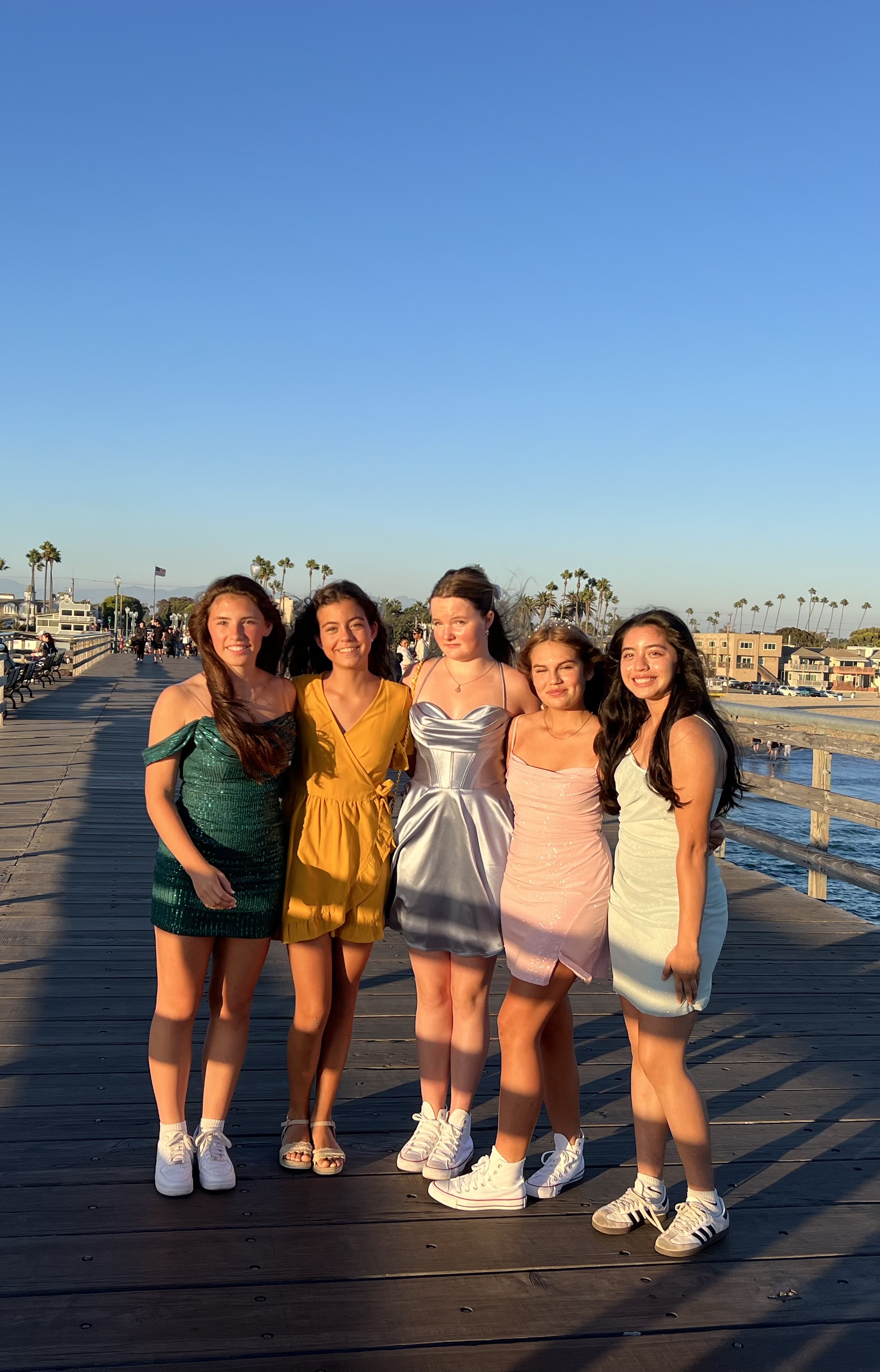 Img: boardwalk, waterfront, shorts, female, girl, person, teen, sandal, shoe, skirt