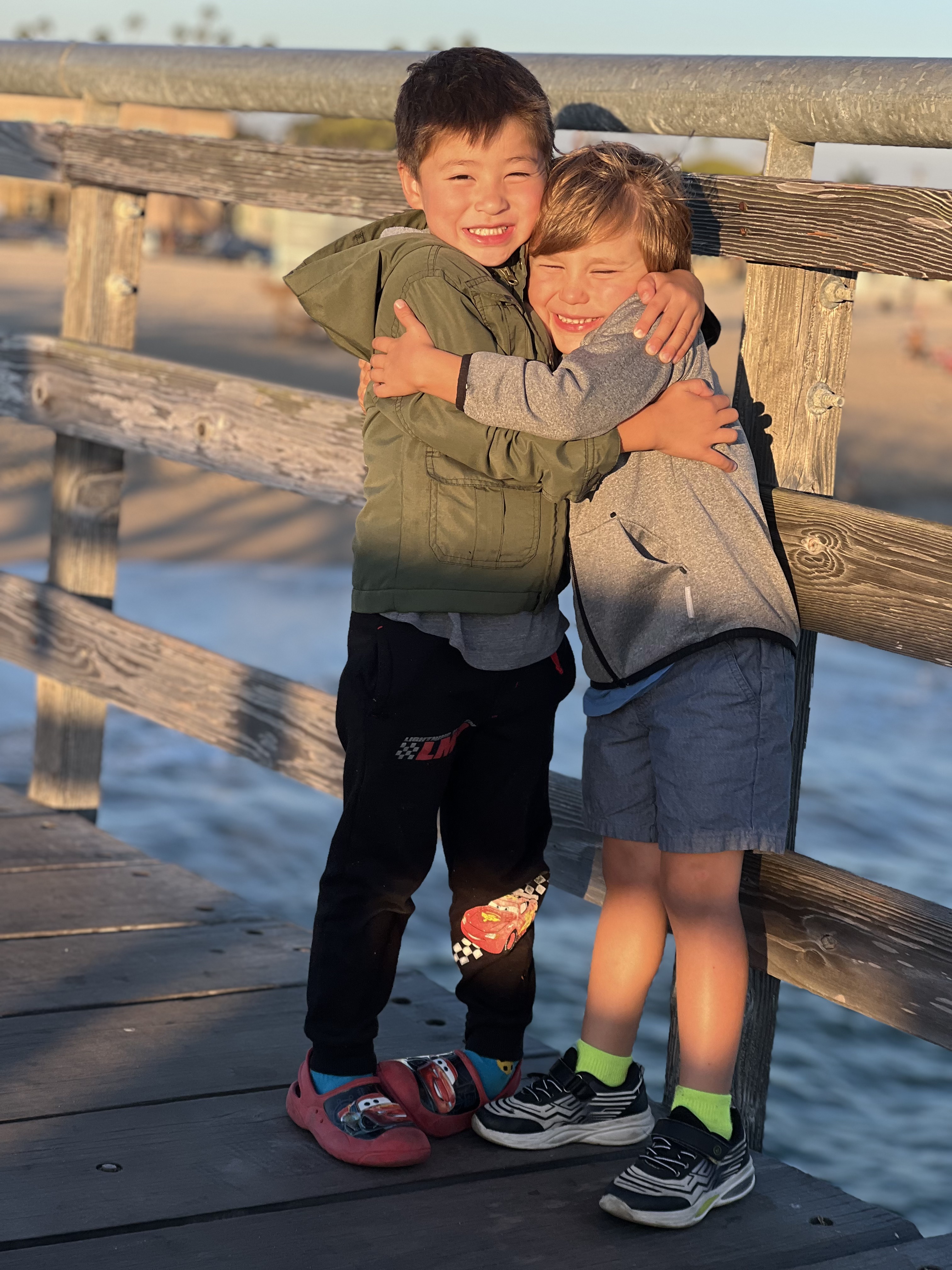 Img: waterfront, shoe, shorts, pier, pants, wood, boy, child, male, person