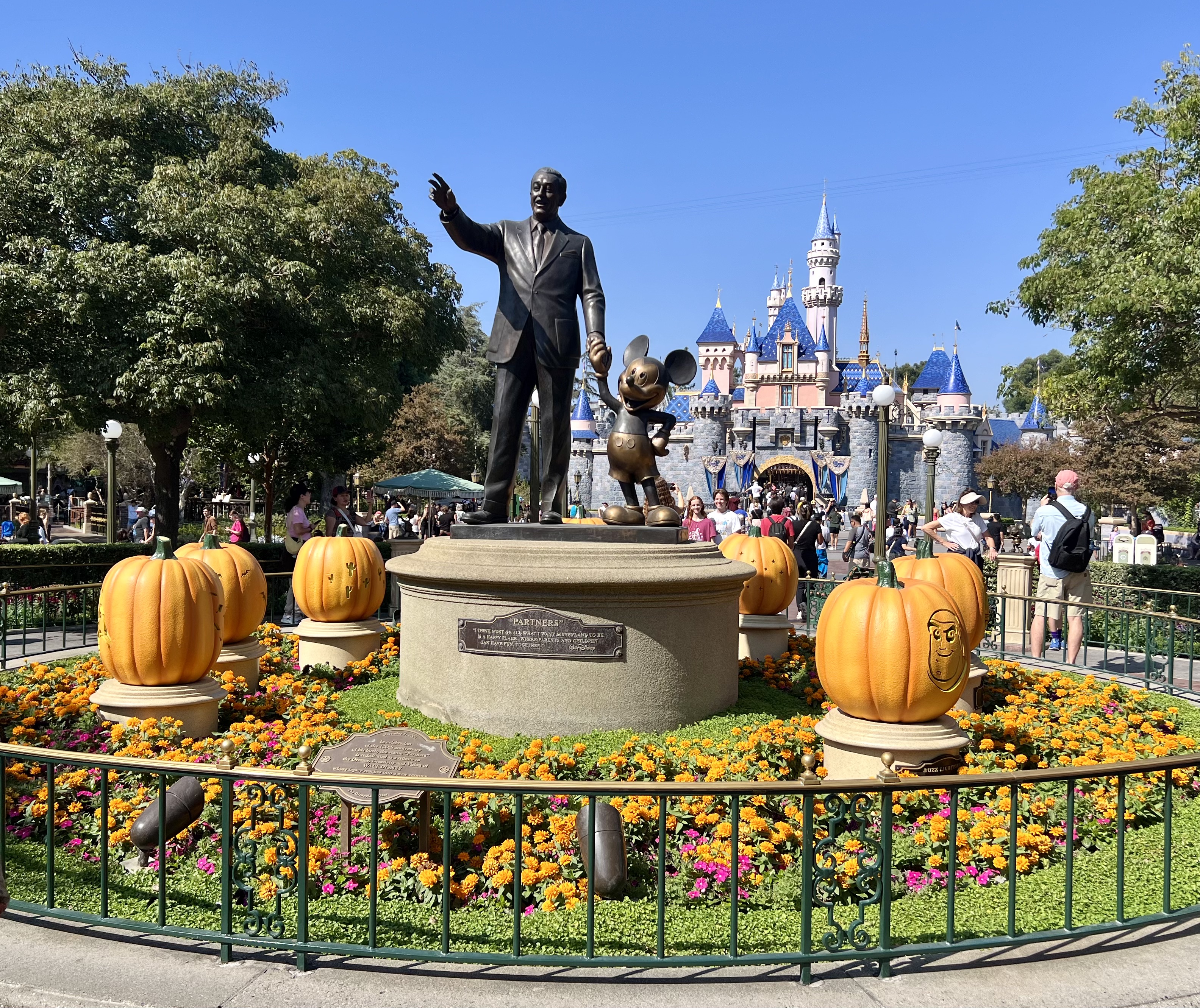 Img: grass, adult, male, man, person, glove, theme park, backpack, park, urban