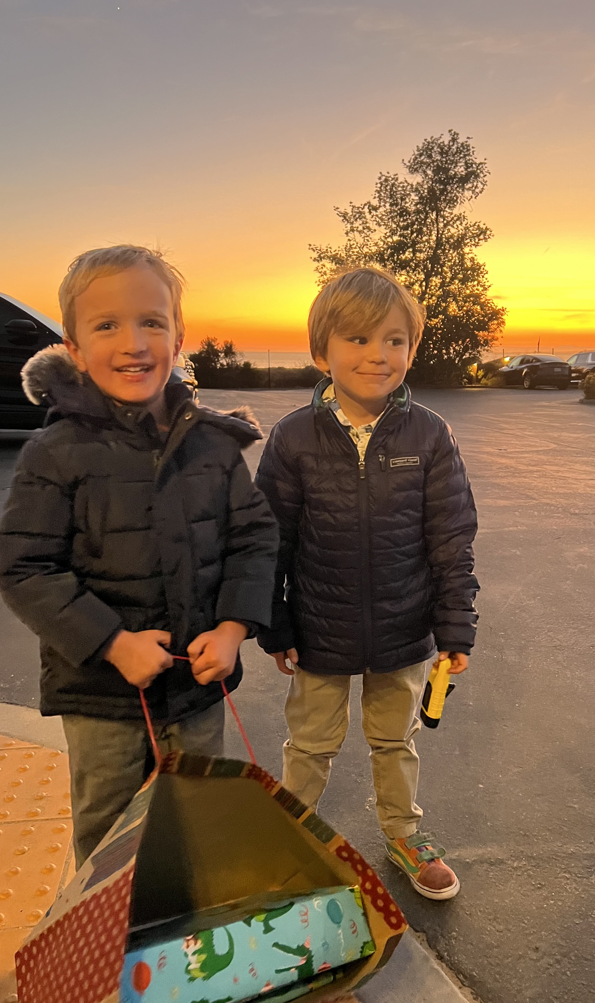 Img: coat, pants, jacket, boy, child, male, person, sky, bag, car