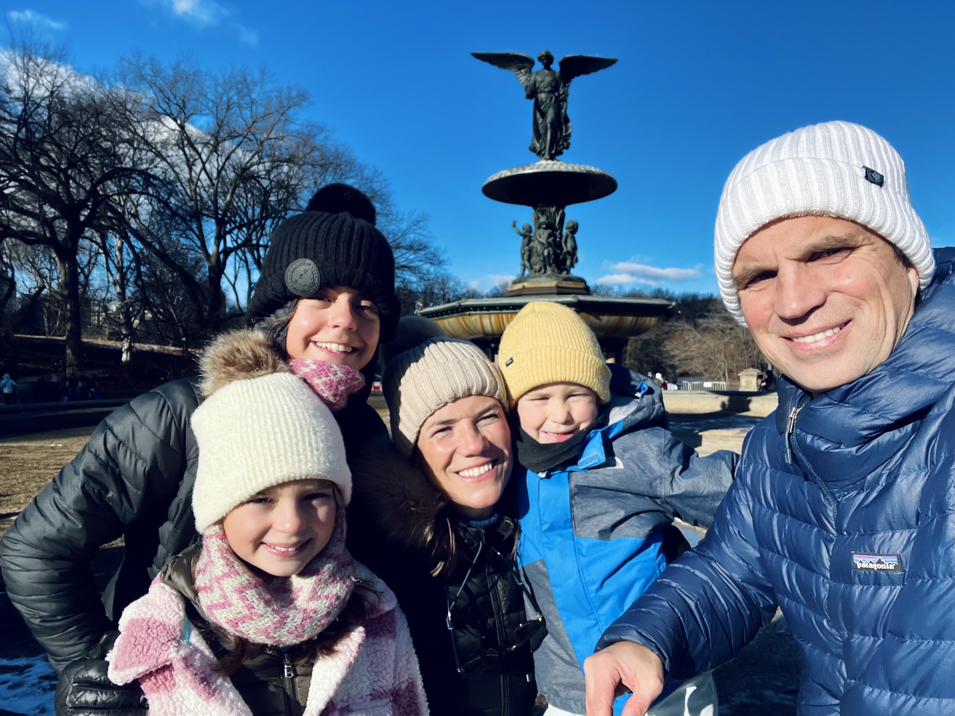 Img: hat, cap, coat, beanie, fountain, jacket, person, baby, adult, woman