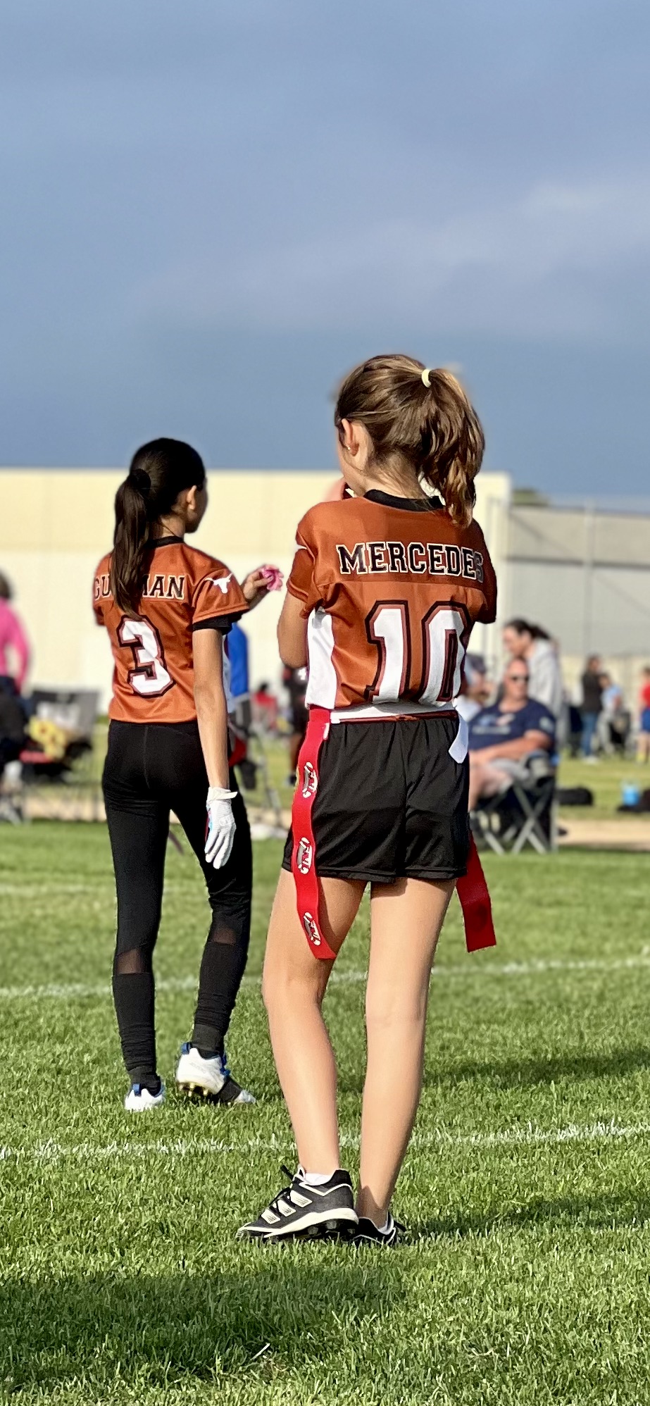 Img: glove, people, person, shoe, female, girl, teen, field, shorts, playing american football