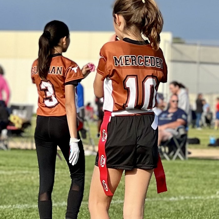 Img: glove, people, person, shoe, female, girl, teen, field, shorts, playing american football