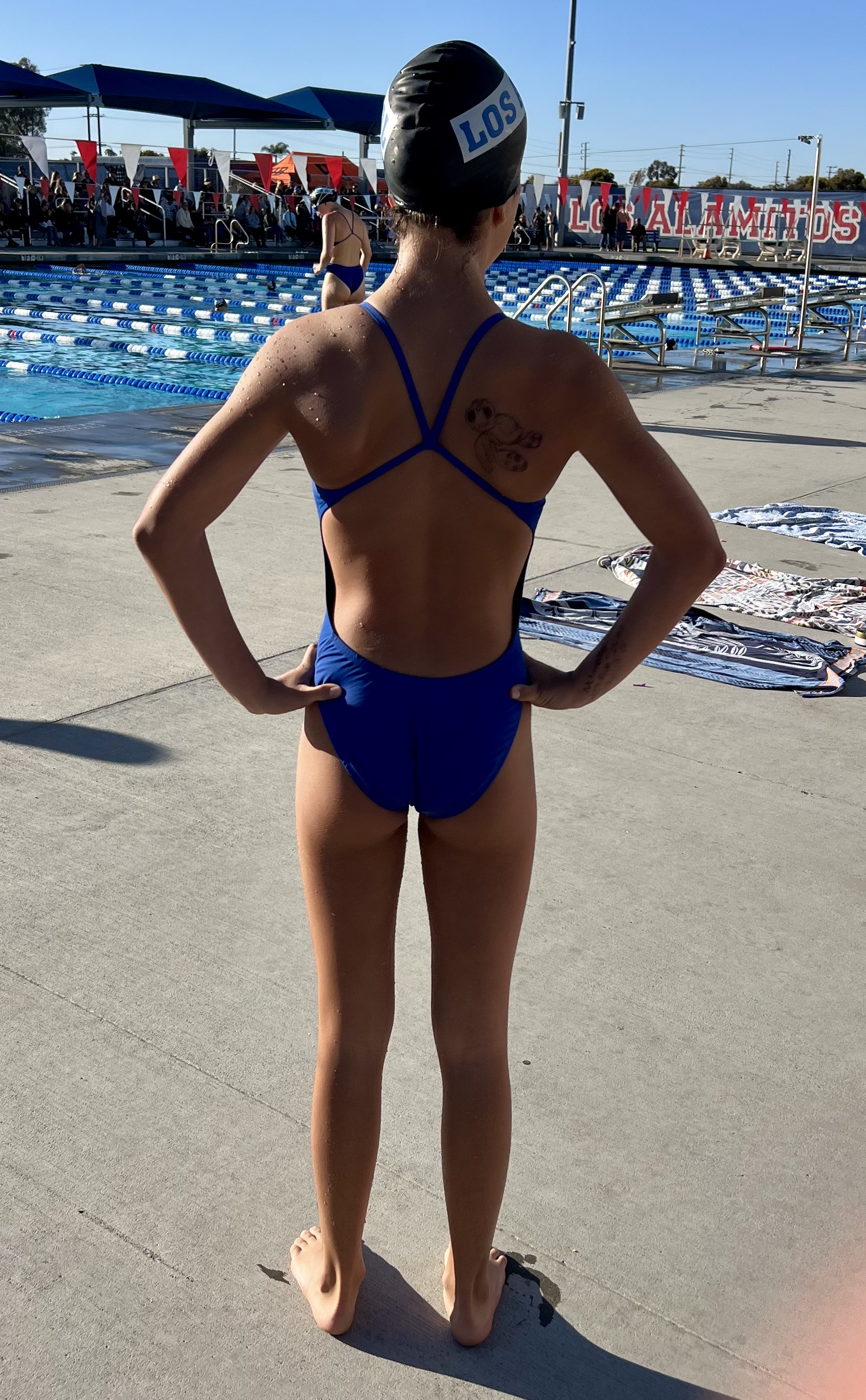 Img: clothing, swimwear, cap, hat, person, back, bathing cap, bikini, footwear, shoe