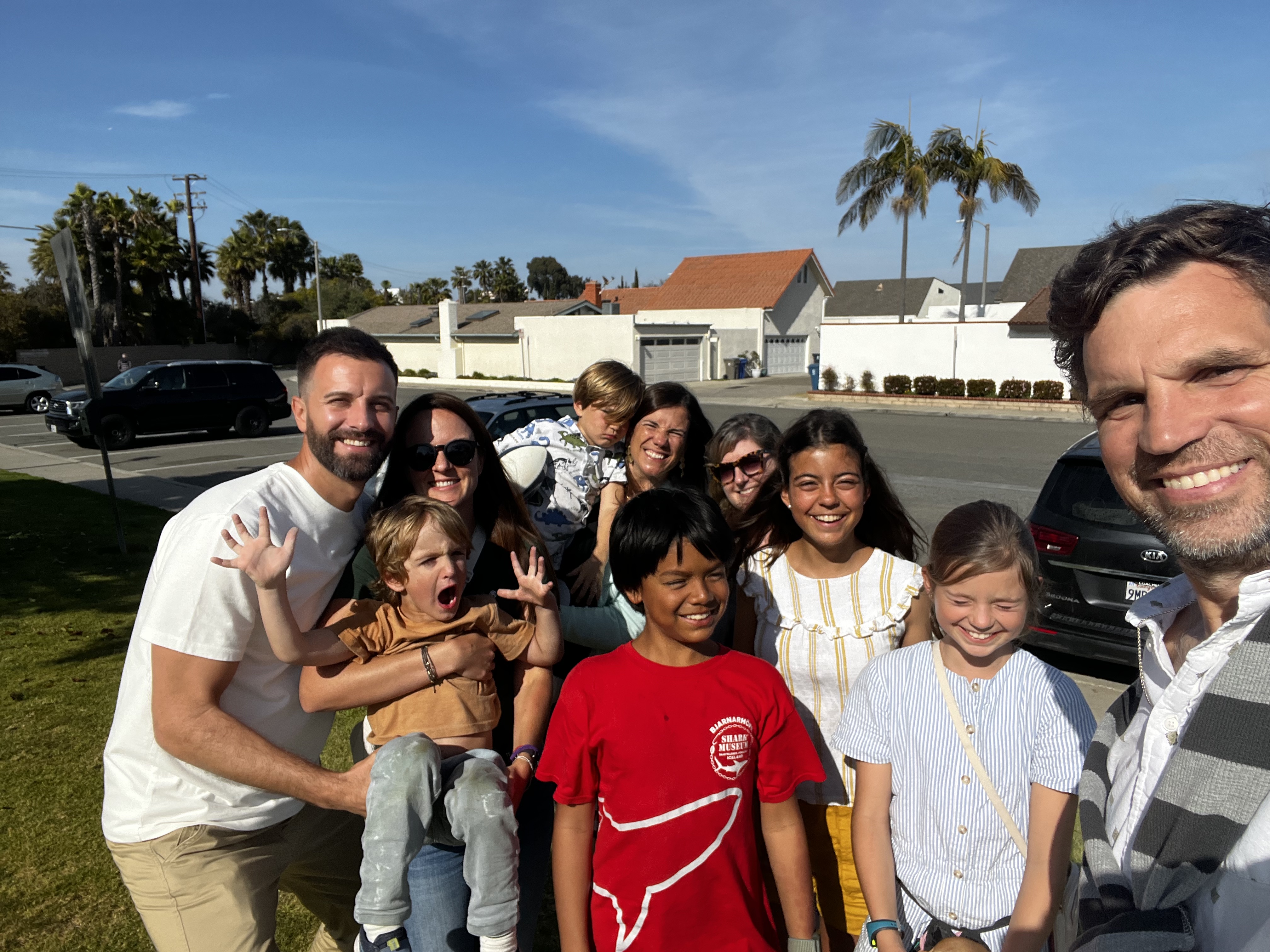 Img: people, t-shirt, neighborhood, photography, portrait, tree, street, shelter, palm tree, pants