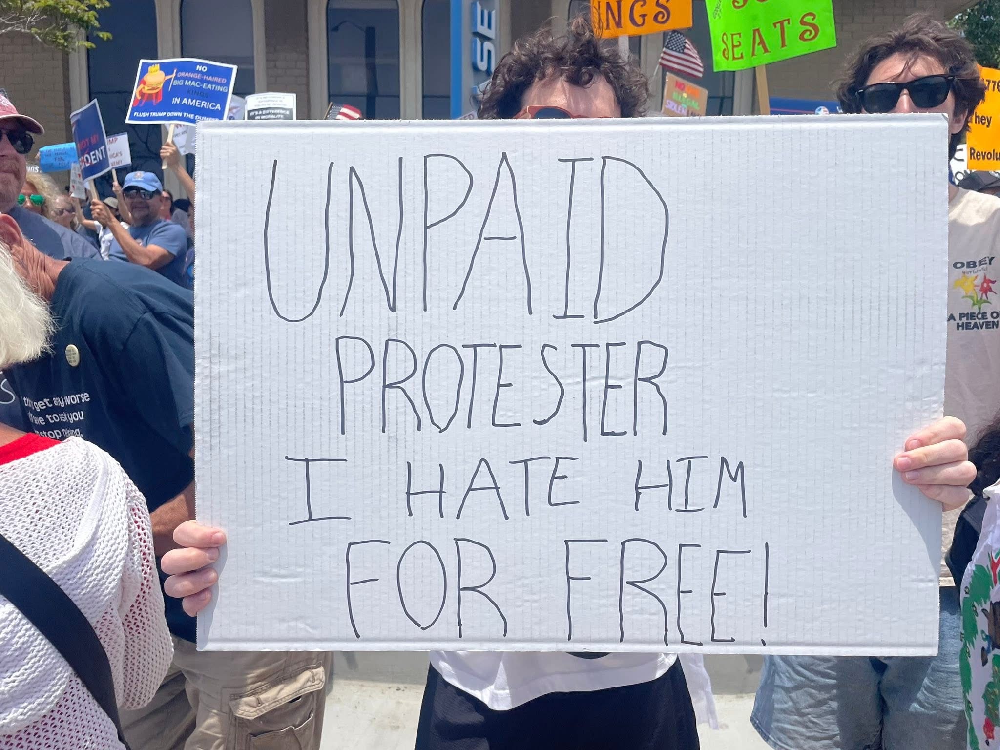 Img: banner, text, accessories, glasses, hat, parade, person, protest, flag, people