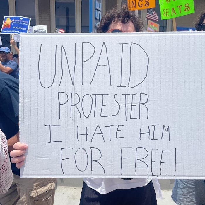 Img: banner, text, accessories, glasses, hat, parade, person, protest, flag, people