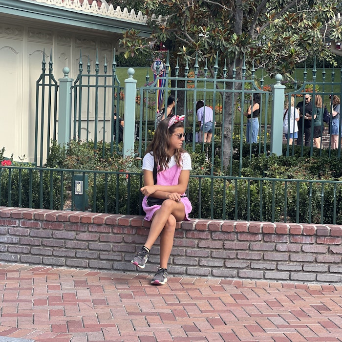 Img: person, sitting, clothing, footwear, shoe, child, female, girl, bag, handbag