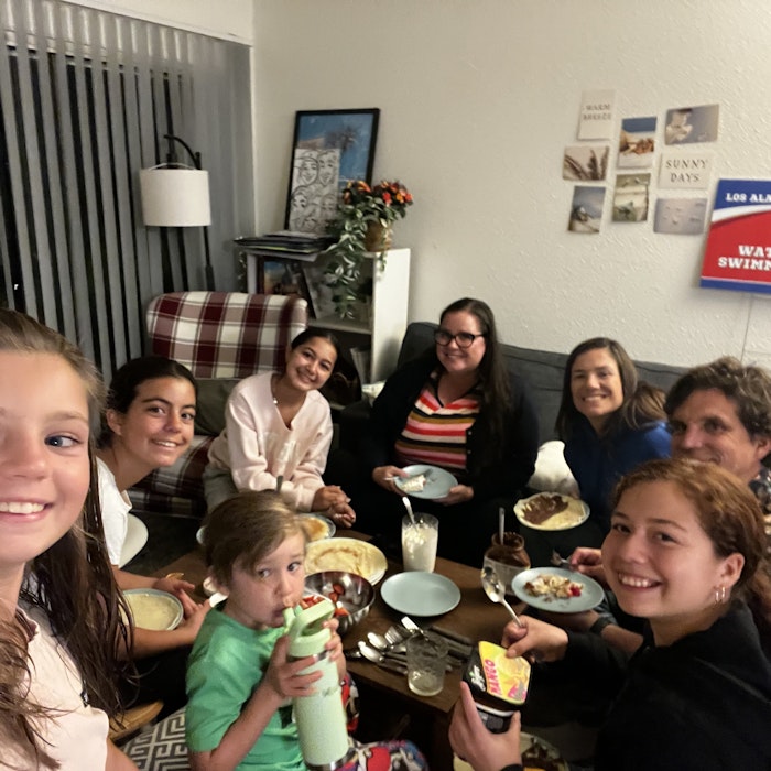 Img: dining room, dining table, table, people, person, meal, adult, female, woman, couch