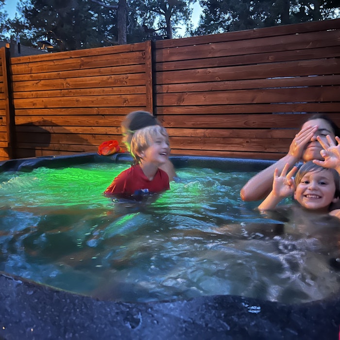 Img: tub, hot tub, child, female, girl, person, baby, backyard, handbag, hat