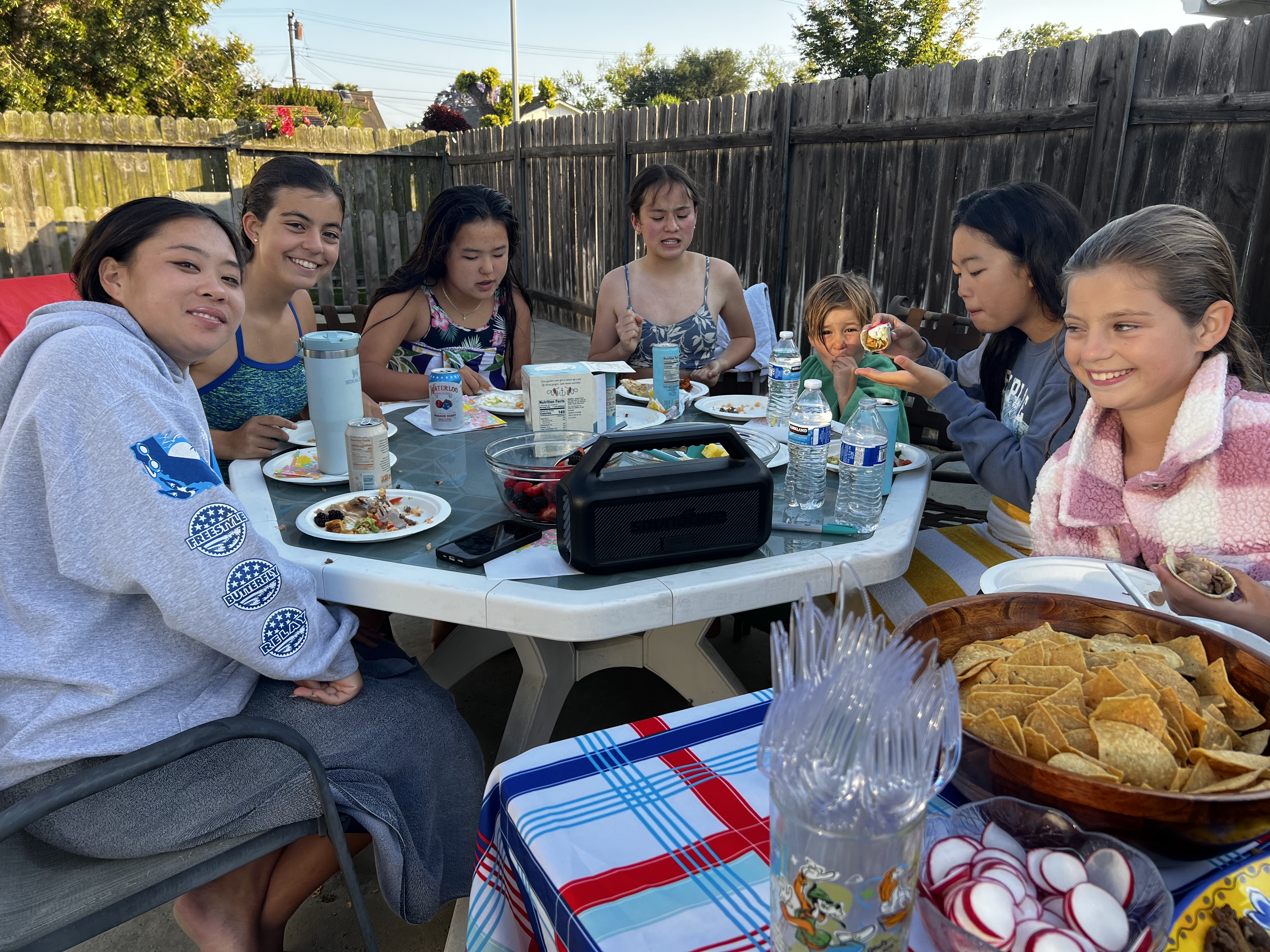 Img: lunch, meal, table, people, person, dining table, plate, mobile phone, brunch, child