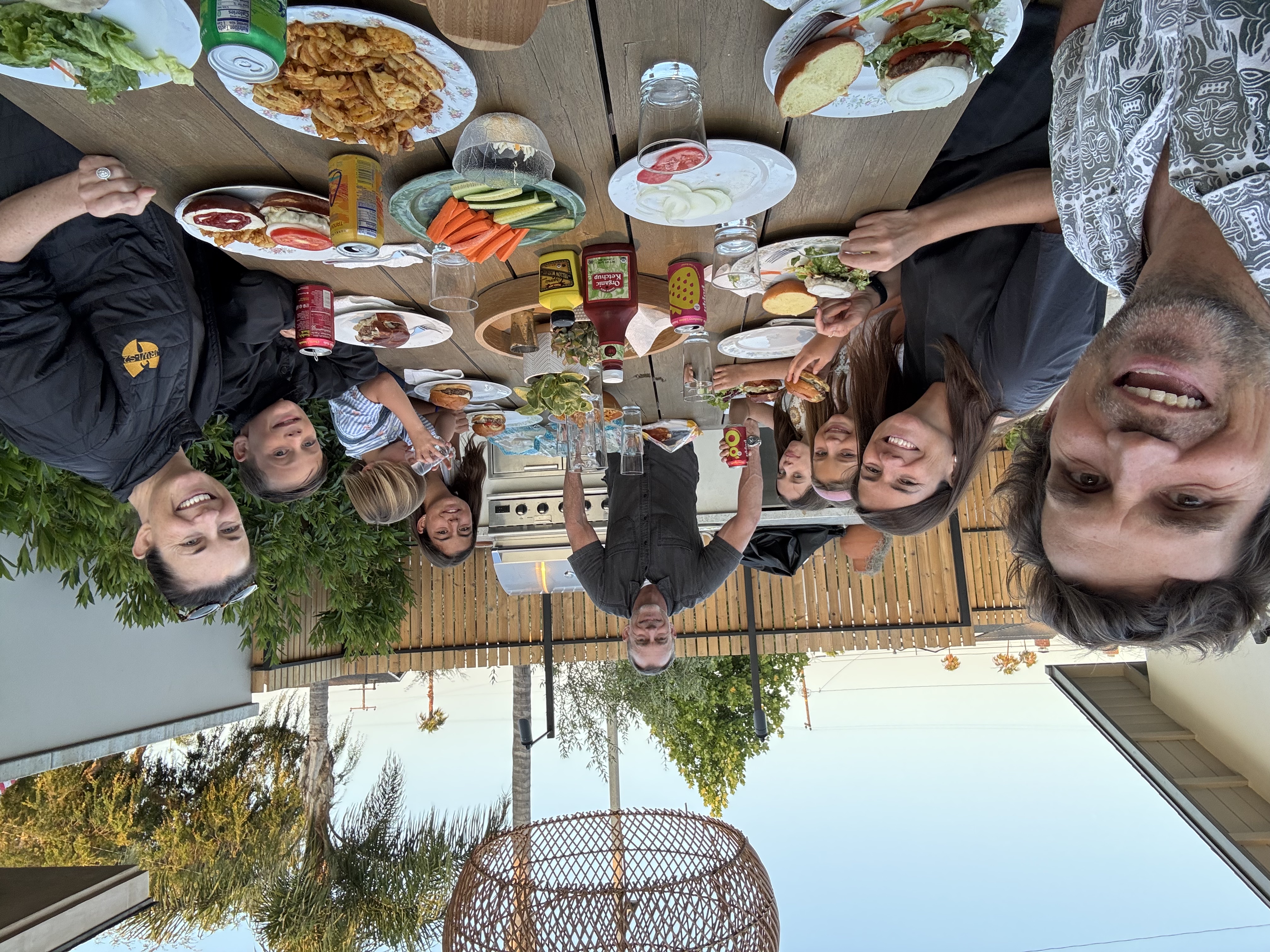 Img: dining table, table, lunch, dining room, potted plant, brunch, cup, burger, man, person