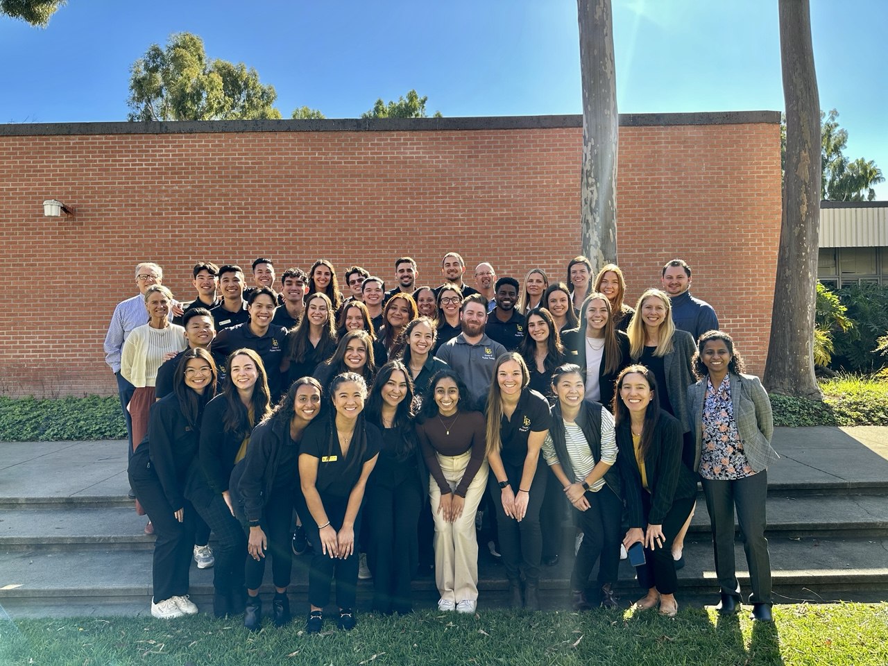 Img: architecture, building, college, groupshot, person, clothing, footwear, shoe