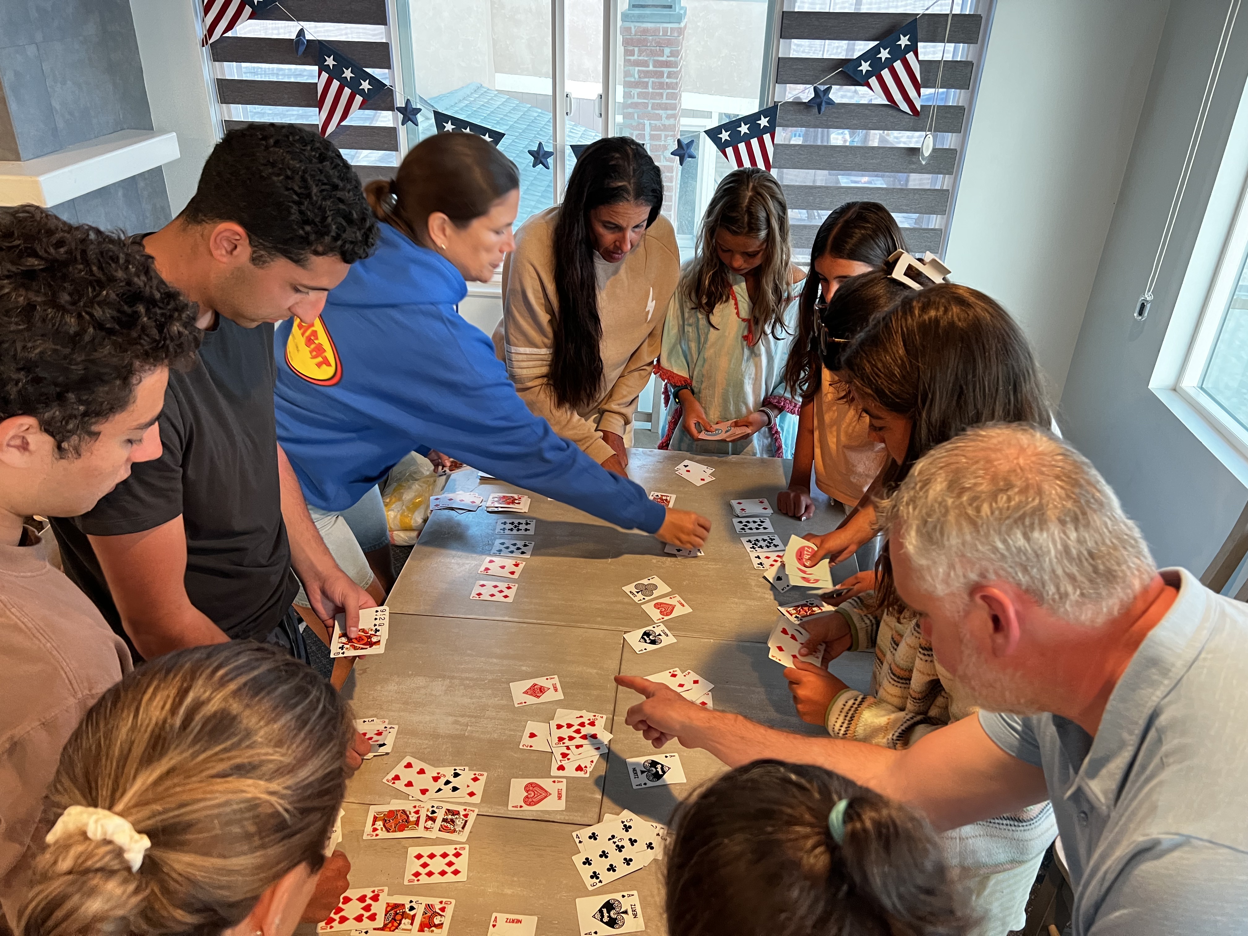 Img: flag, person, adult, female, woman, child, girl, desk, furniture, table