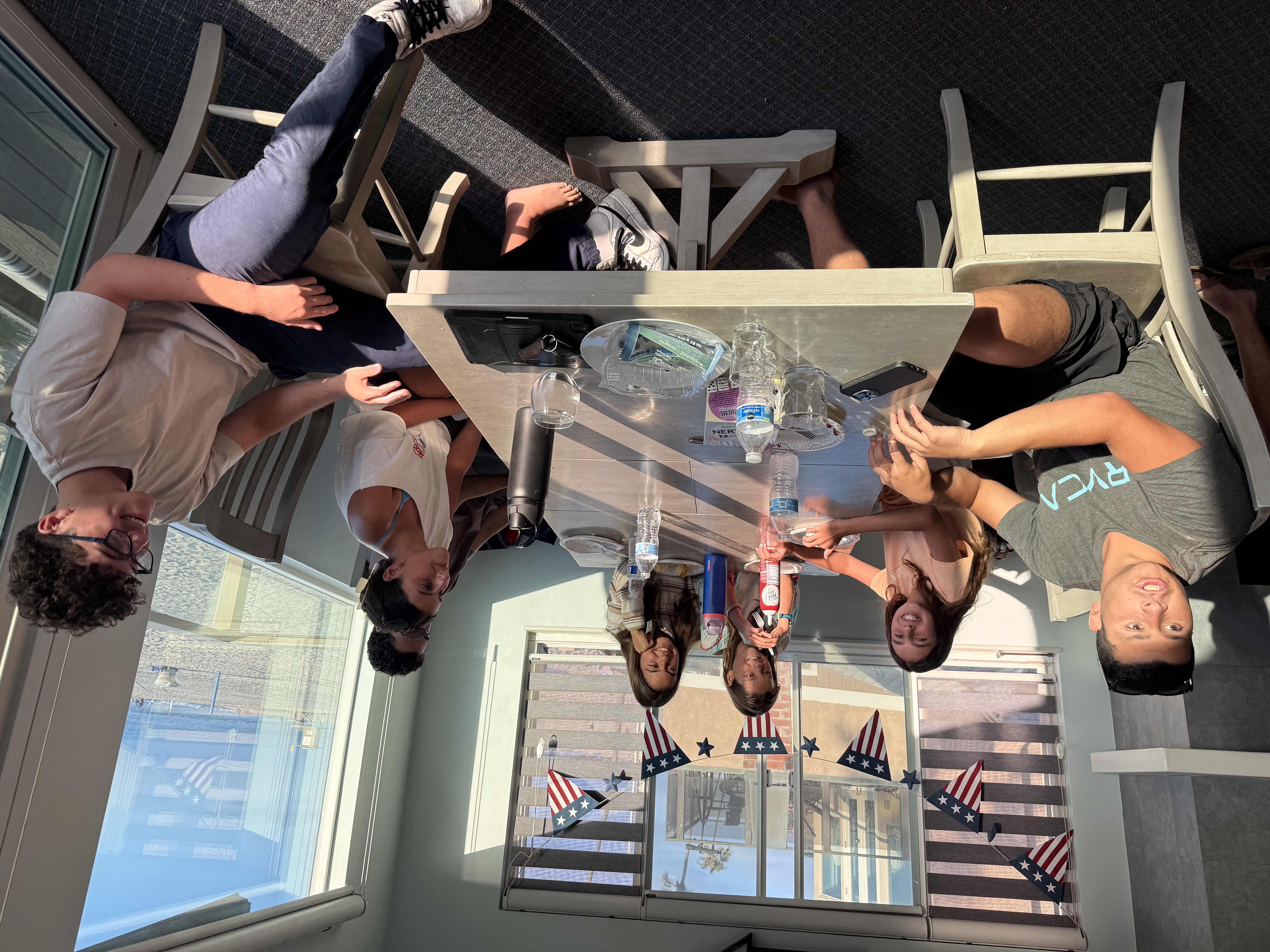 Img: table, dining room, dining table, shoe, boy, male, person, teen, chair, tabletop