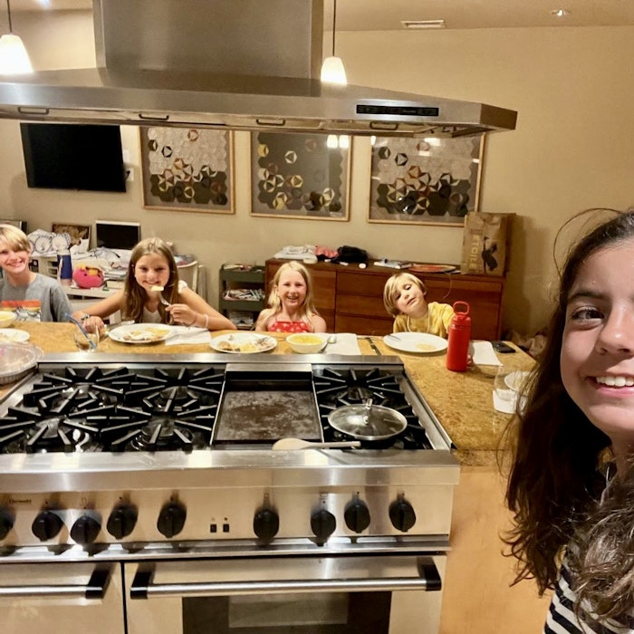 Img: child, female, girl, person, kitchen, people, plate, cooktop, lamp, monitor