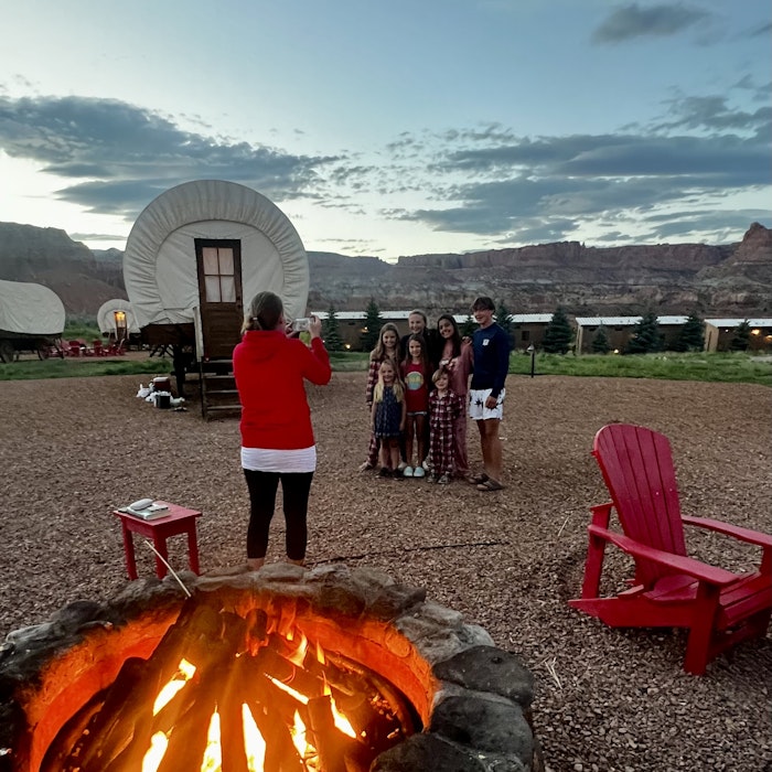 Img: adult, female, person, woman, chair, furniture, bonfire, fire, flame, electrical device