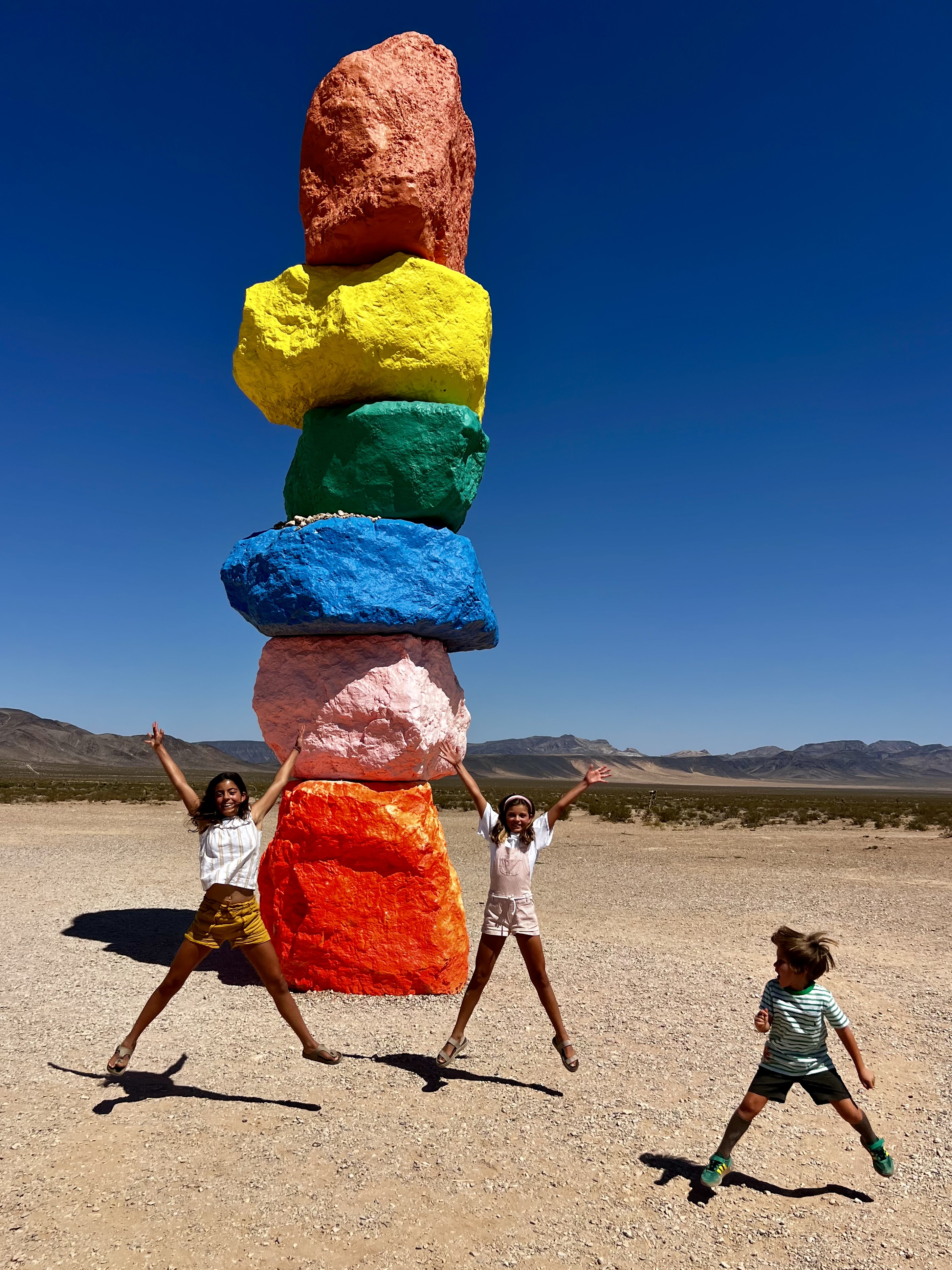Img: rock, person, female, girl, teen, shorts, shoe, walking, glove, outdoors