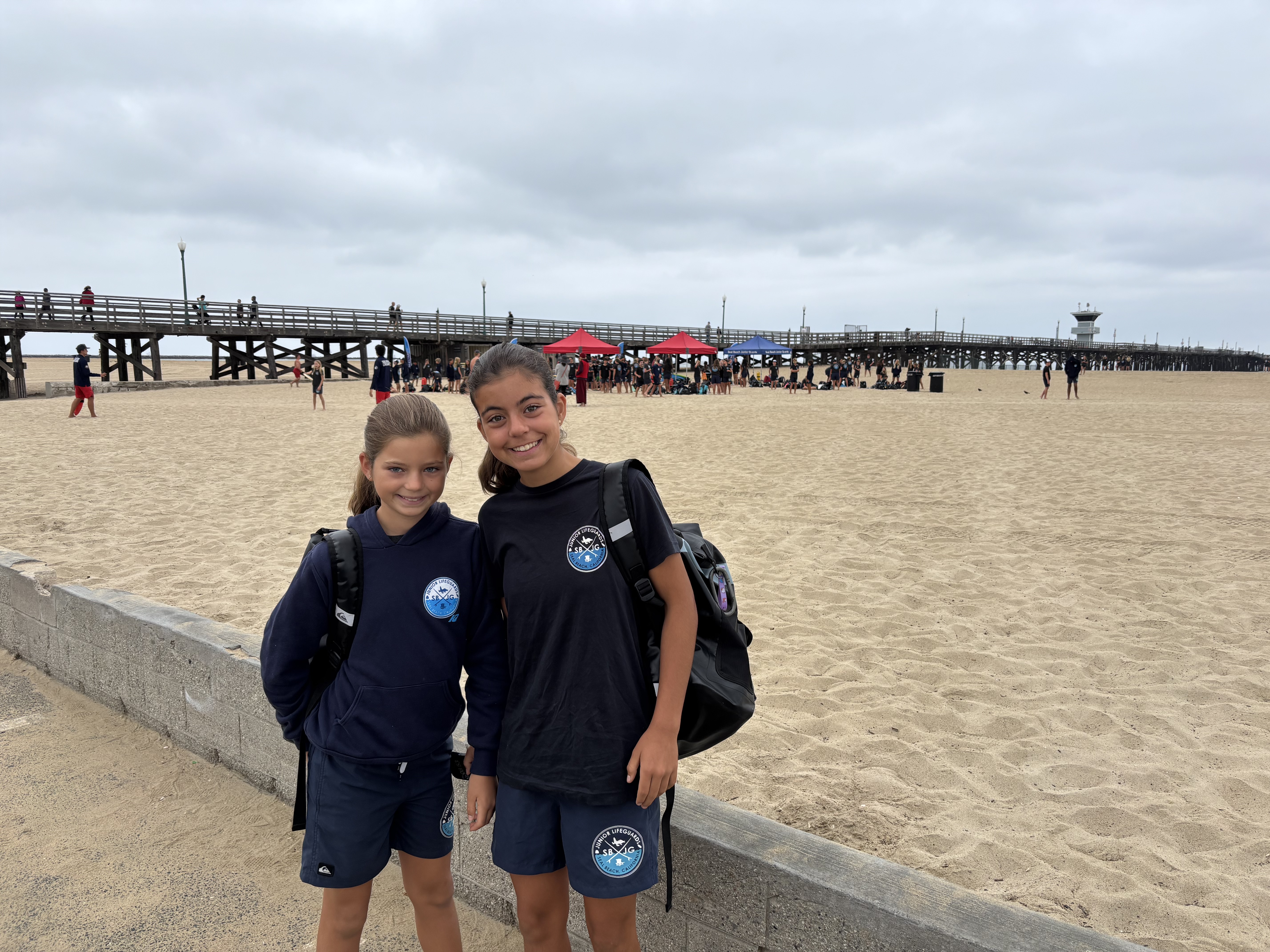 Img: water, waterfront, pier, photography, t-shirt, person, portrait, shorts, beach, handbag