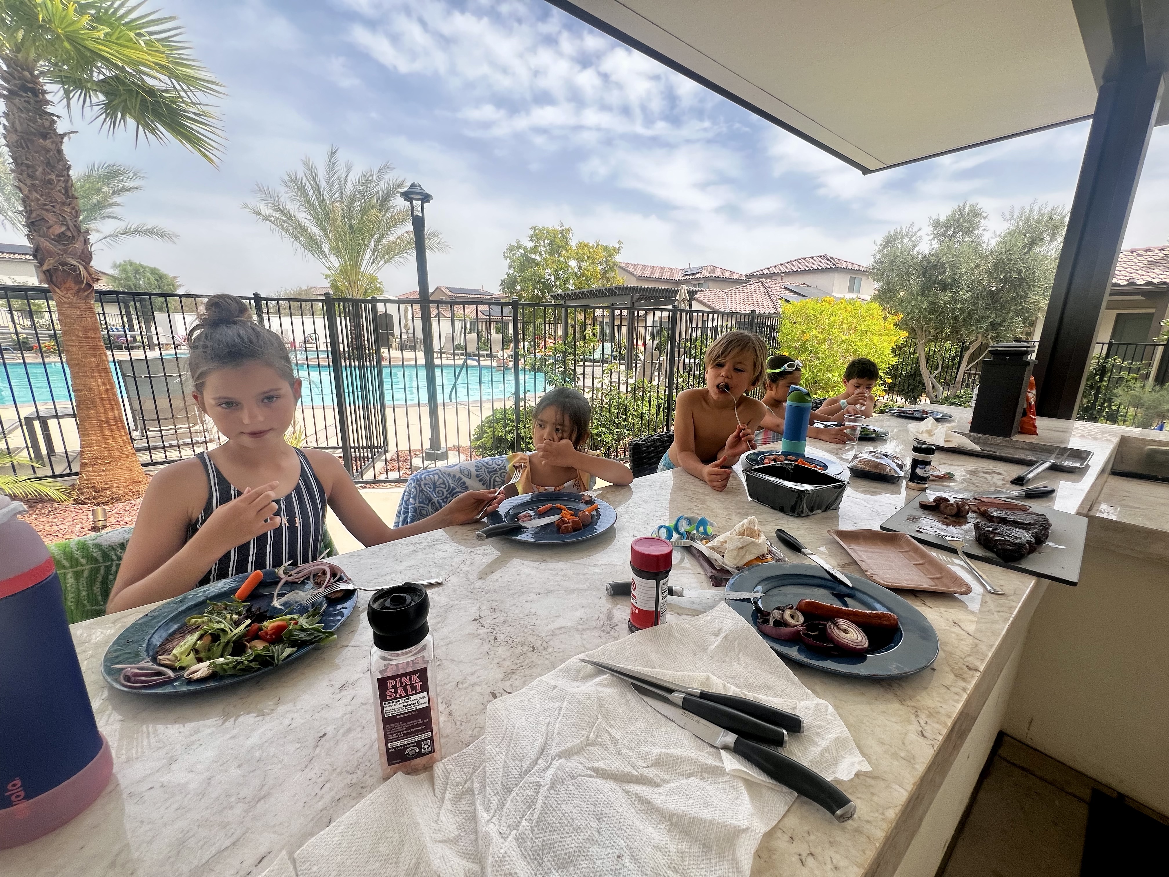 Img: brunch, dining table, furniture, table, person, plate, summer, hat, knife, dining room