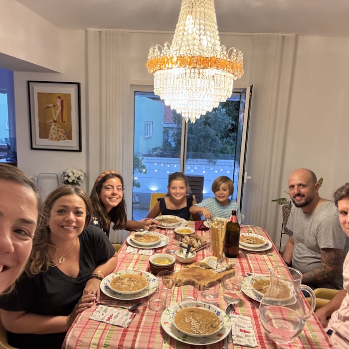 Img: dining room, dining table, table, people, person, chandelier, adult, female, woman, man