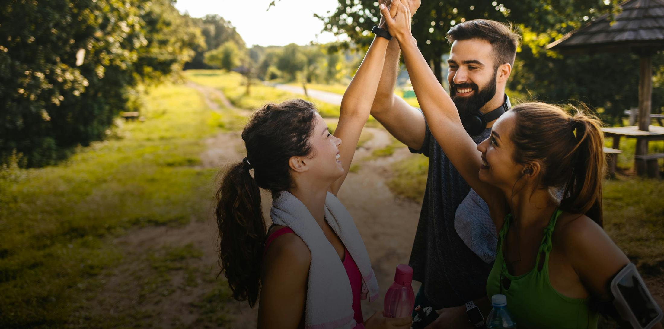 three people high-fiving