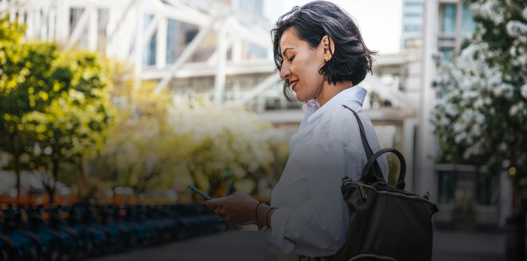 woman looking at her phone smiling